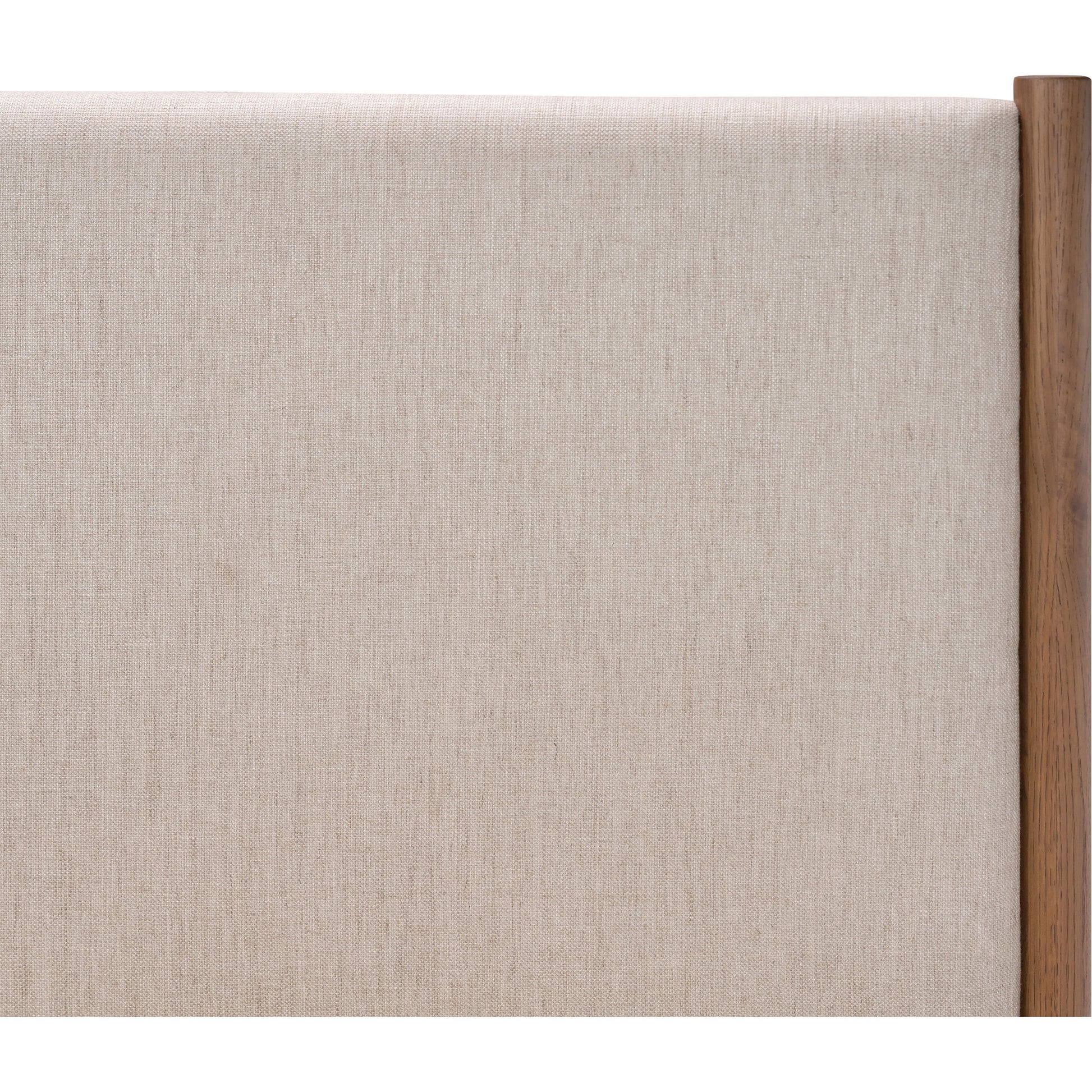 Rounded, chunky dowel legs in an amber oak finish frame the neutral, linen-like upholstered headboard of this bed frame Amethyst Home provides interior design, new home construction design consulting, vintage area rugs, and lighting in the Miami metro area.