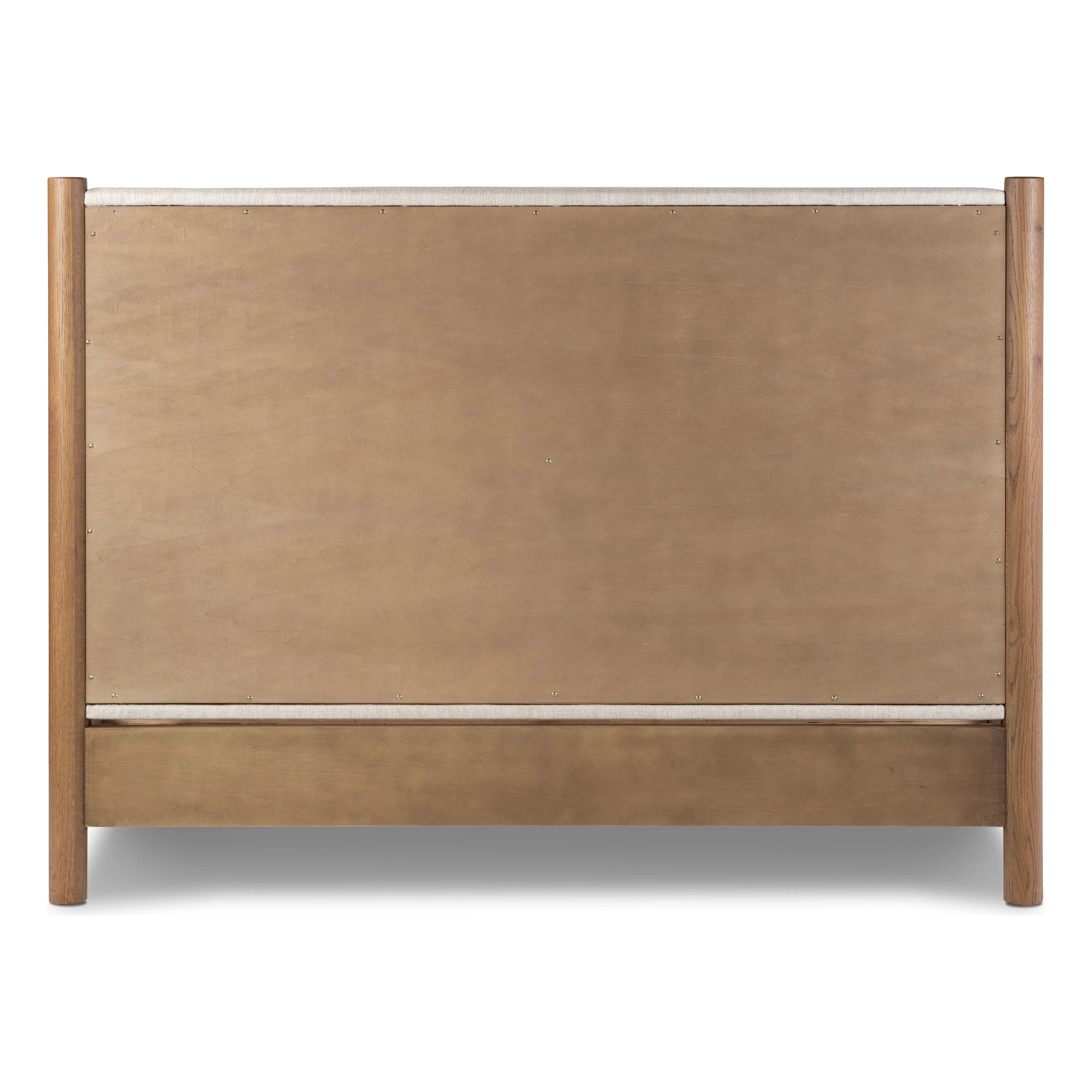 Rounded, chunky dowel legs in an amber oak finish frame the neutral, linen-like upholstered headboard of this bed frame Amethyst Home provides interior design, new home construction design consulting, vintage area rugs, and lighting in the Portland metro area.
