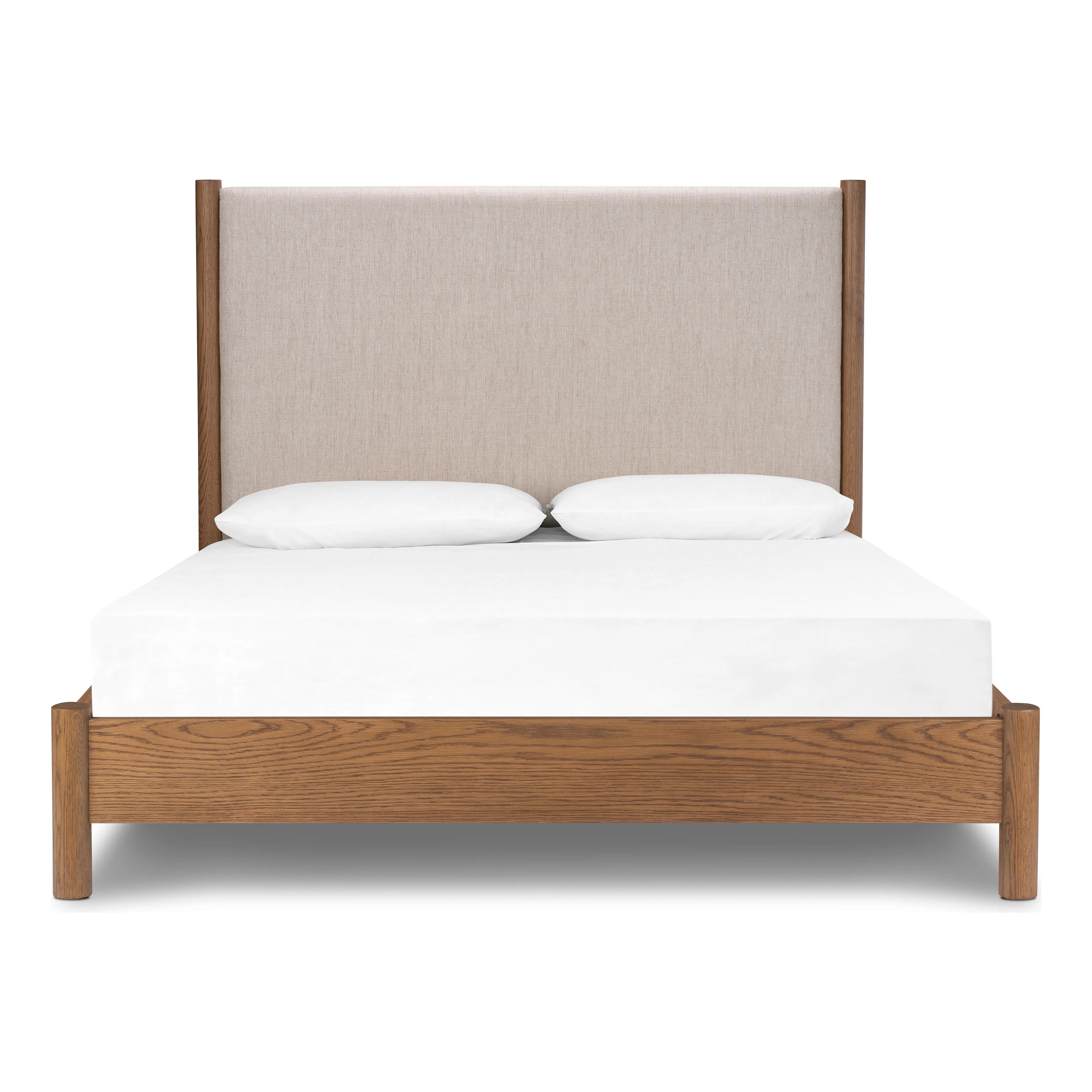 Rounded, chunky dowel legs in an amber oak finish frame the neutral, linen-like upholstered headboard of this bed frame Amethyst Home provides interior design, new home construction design consulting, vintage area rugs, and lighting in the Winter Garden metro area.