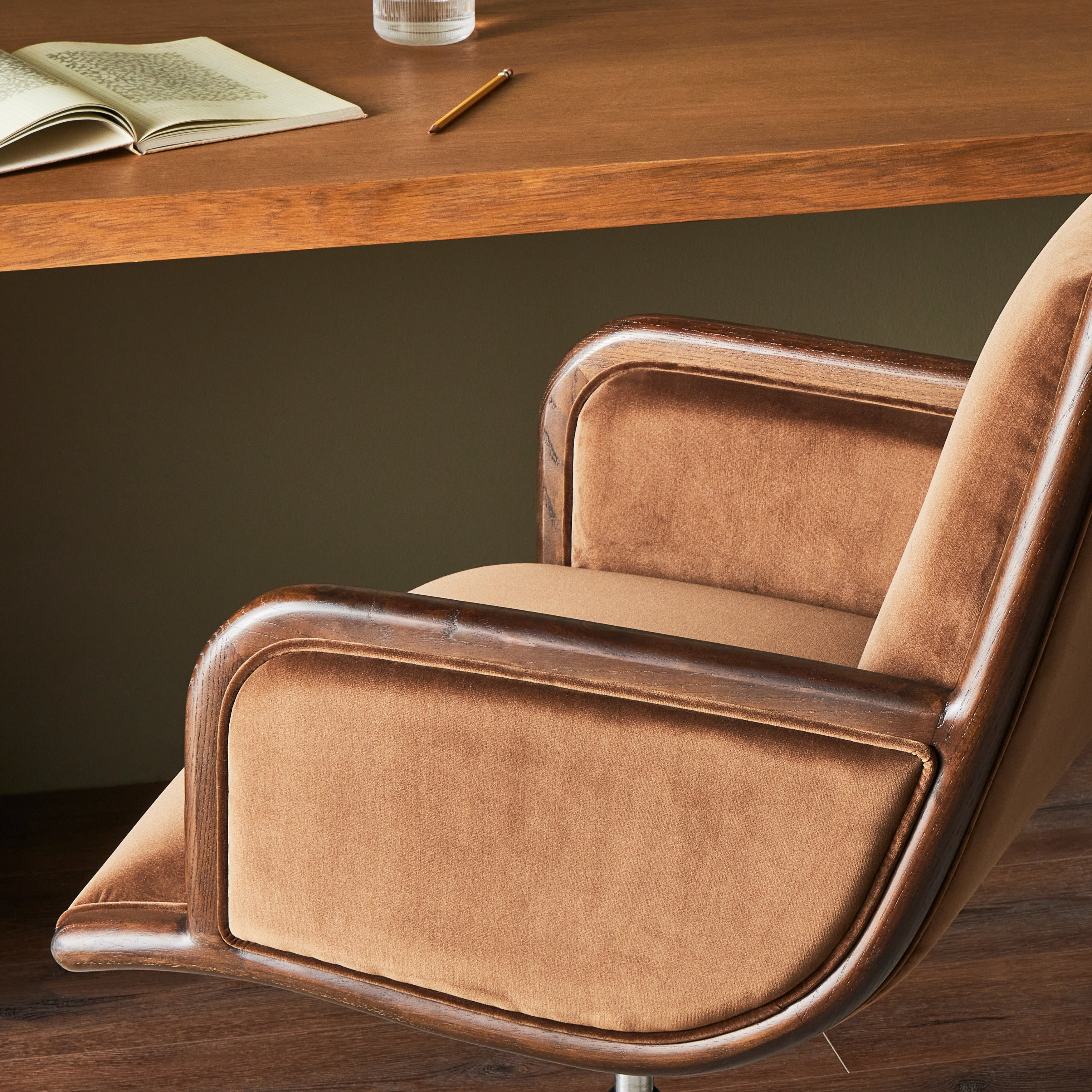 This comfort-driven take on the modern desk chair features velvety cocoa-colored upholstery, pared with a wooden frame. Casters and seat height adjustability for ease as you work. Amethyst Home provides interior design, new construction, custom furniture, and area rugs in the Kansas City metro area.