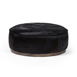 This large, round ottoman of textural hair-on hide brings with it a hip retro vibe as a coffee table or extra seating.  Covered in soft and luminous black hair-on hide, which is naturally warm and textural with authentic highlights. Amethyst Home provides interior design, new construction, custom furniture, and area rugs in the Laguna Beach metro area.