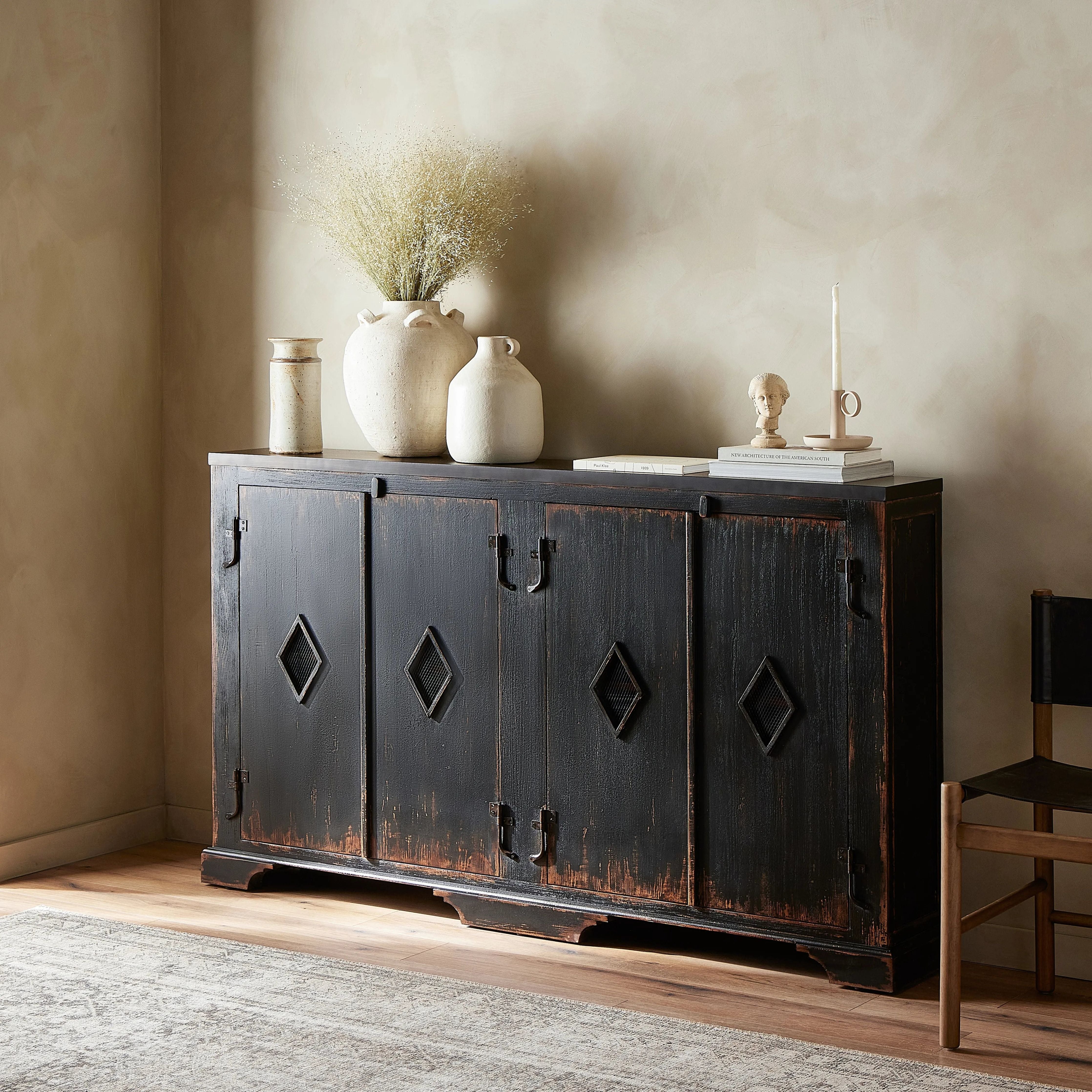 By the makers at Van Thiel, known for their antique-inspired pieces and hand-applied finishes.  This wide but slim solid pine cabinet features door fronts with diamond cutout details and wire mesh inserts. Detailed with antique-inspired hardware and hinges. Metal-clad top in oil-rubbed bronze finish. Amethyst Home provides interior design, new home construction design consulting, vintage area rugs, and lighting in the Alpharetta metro area.