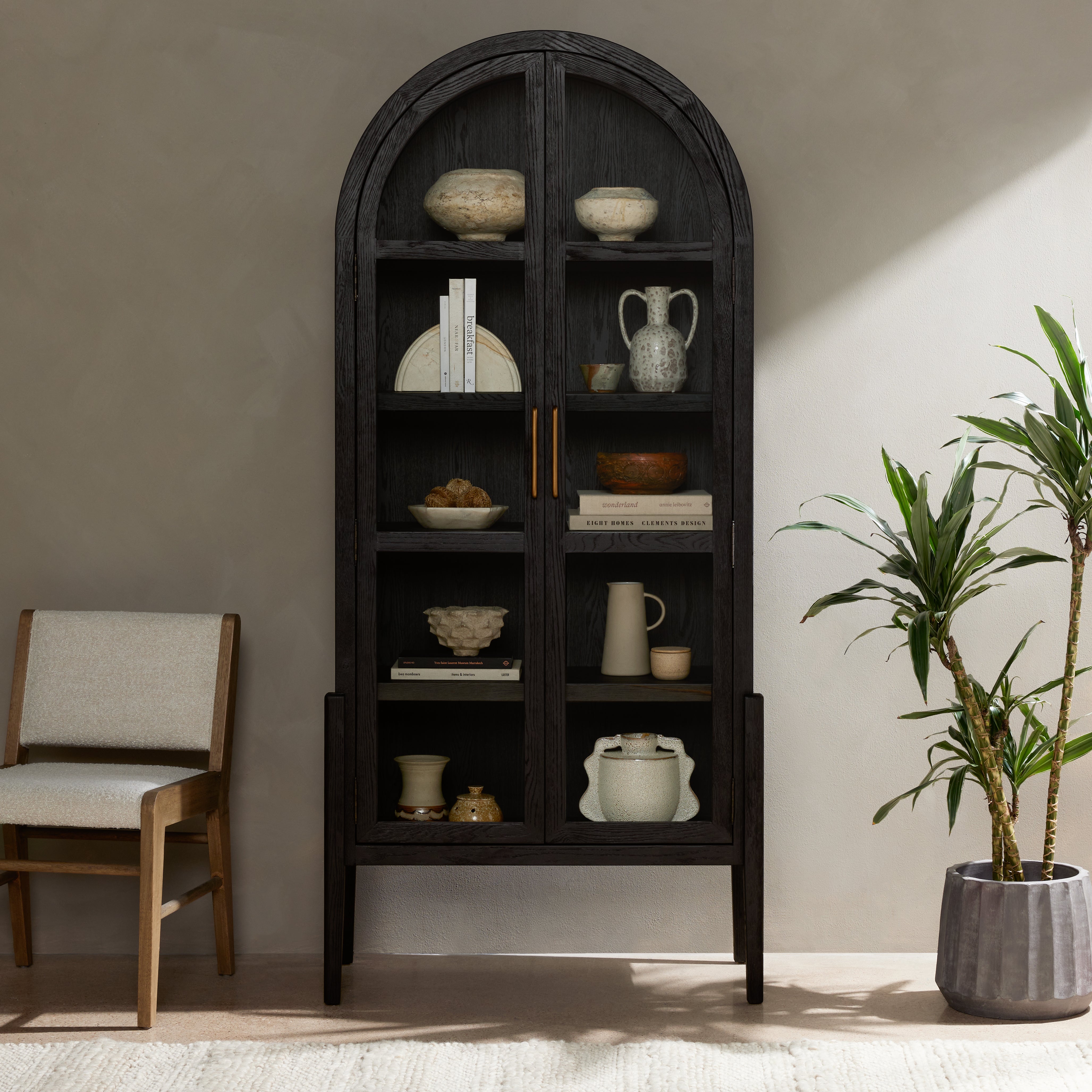 Featuring Tolle Drifted Matte Black Cabinet by Four Hands at Amethyst Home. Made from black-finished solid oak, French-inspired cabinetry features an arched top, spacious interior and a clear glass front for storage and display.
Collection: IrondaleColors: Antique Brass ,Drifted BlackMaterials: Iron ,Solid Oak Weight: 185.3 lbsOverall Dimensions: 38"W x 19"L x 84"HVolume: 51.74 c. Amethyst Home provides interior design, new construction, custom furniture, and area rugs in the Calabasas metro area.