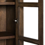 This minimal-inspired bookcase is crafted from a mix of solid oak and worn oak veneer. Featuring glass-front doors and spacious shelves for storage and display.Collection: Bennet Amethyst Home provides interior design, new home construction design consulting, vintage area rugs, and lighting in the Kansas City metro area.