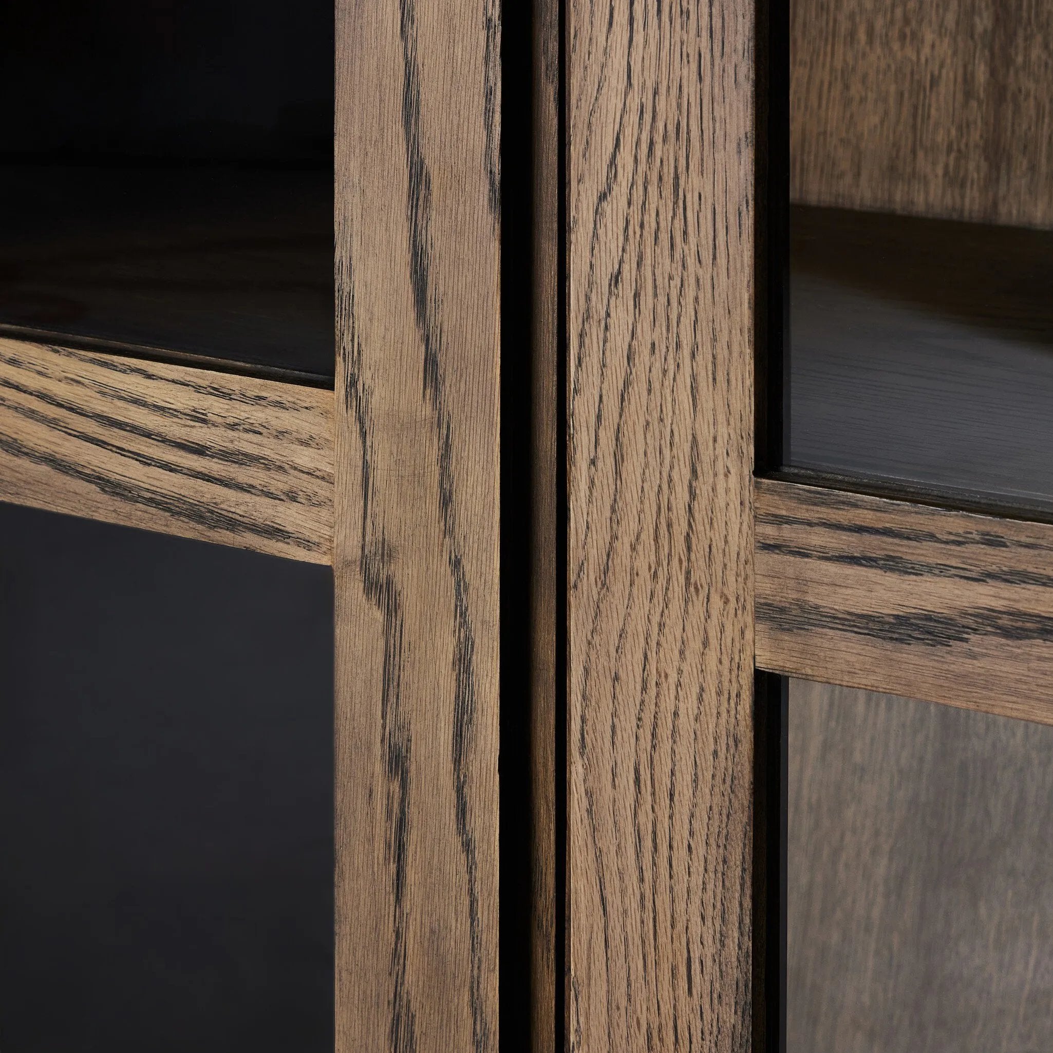 This minimal-inspired bookcase is crafted from a mix of solid oak and worn oak veneer. Featuring glass-front doors and spacious shelves for storage and display.Collection: Bennet Amethyst Home provides interior design, new home construction design consulting, vintage area rugs, and lighting in the Tampa metro area.