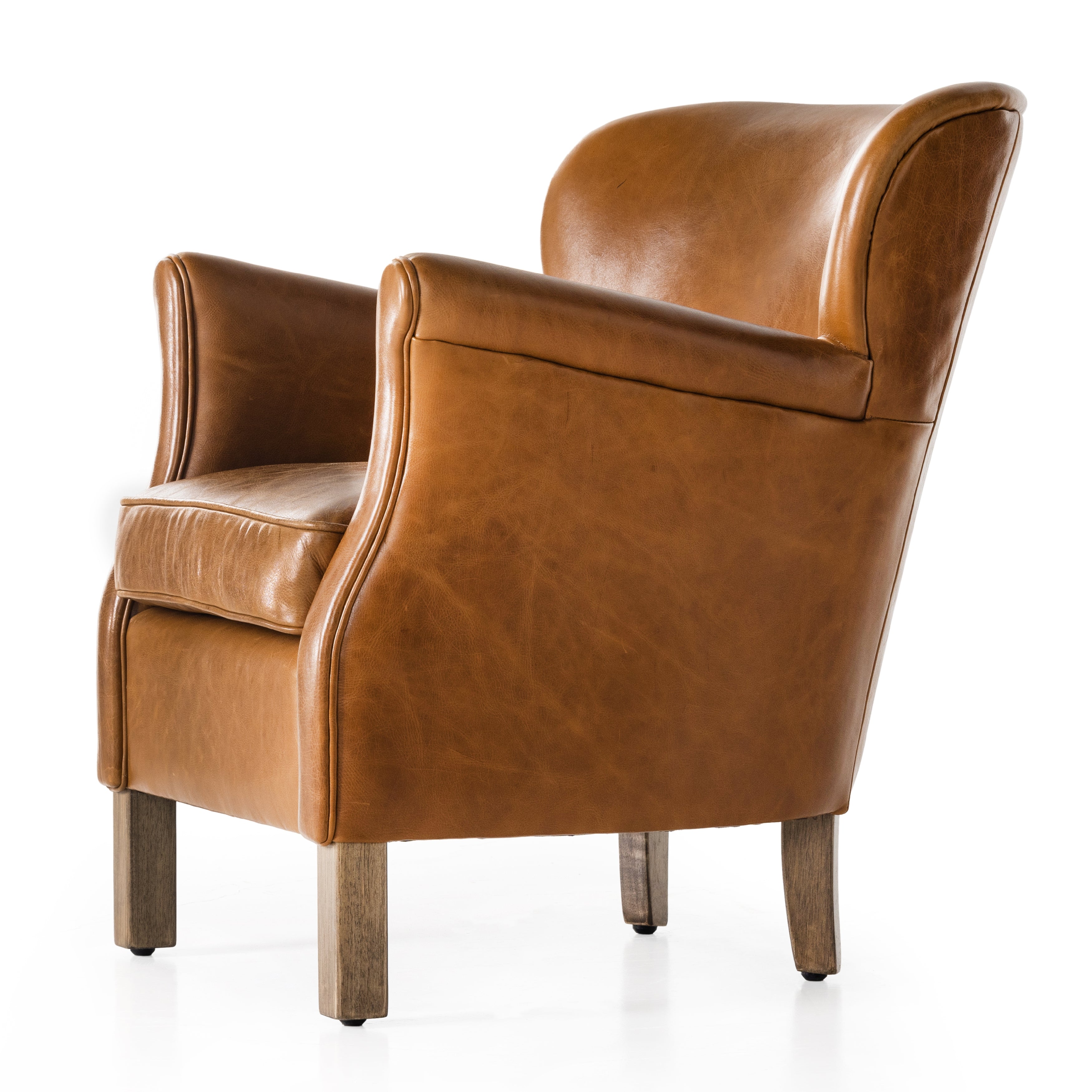 A statement seat all its own. This regal Parisian club chair is honored with a profound scooped back and rolled arms in classic, lived in tan top-grain leather. Amethyst Home provides interior design, new construction, custom furniture, and area rugs in the Calabasas metro area.