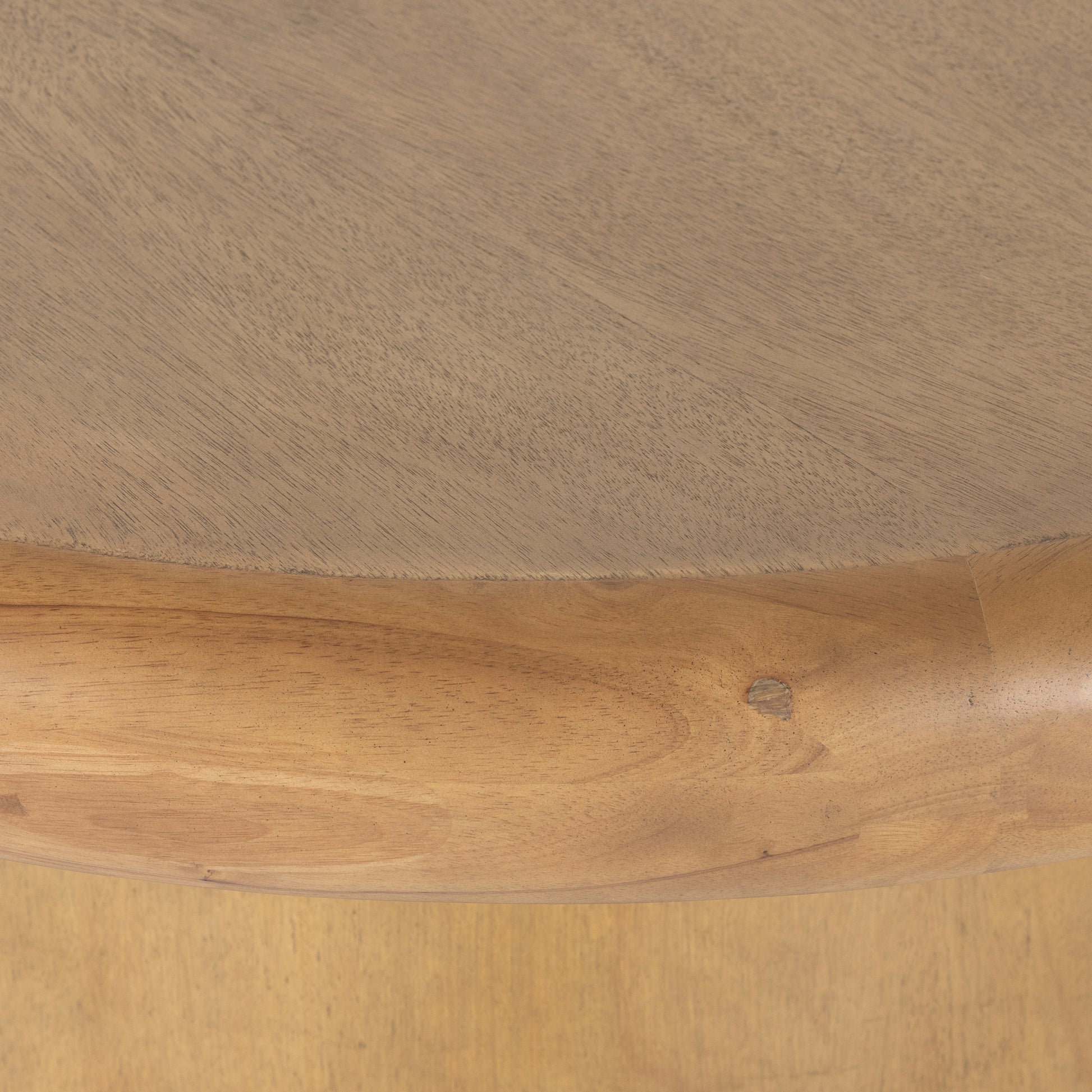 The Zach coffee table in burnished parawood features a pedestal-style base on a rounded tabletop with bullnose edging, for style and softness alike. Amethyst Home provides interior design, furniture, rugs, and design services in the Calabasas metro area.