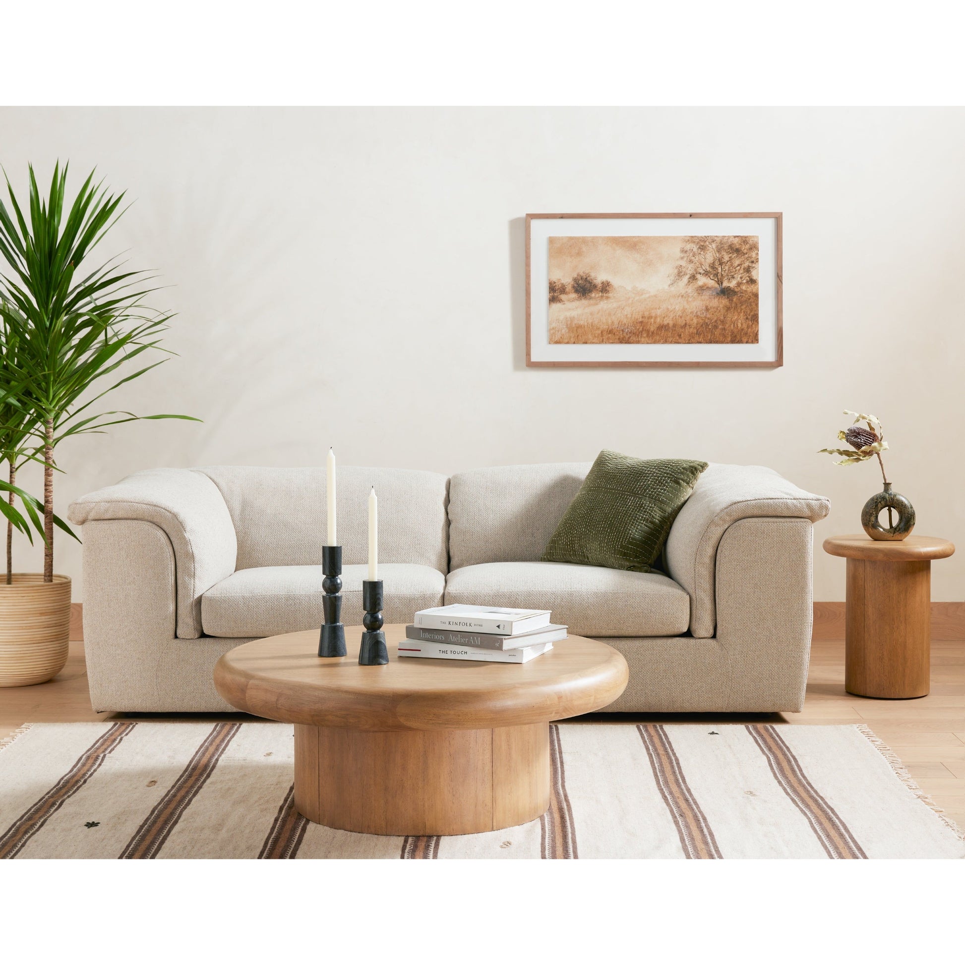 The Zach coffee table in burnished parawood features a pedestal-style base on a rounded tabletop with bullnose edging, for style and softness alike. Amethyst Home provides interior design, furniture, rugs, and design services in the Seattle metro area.