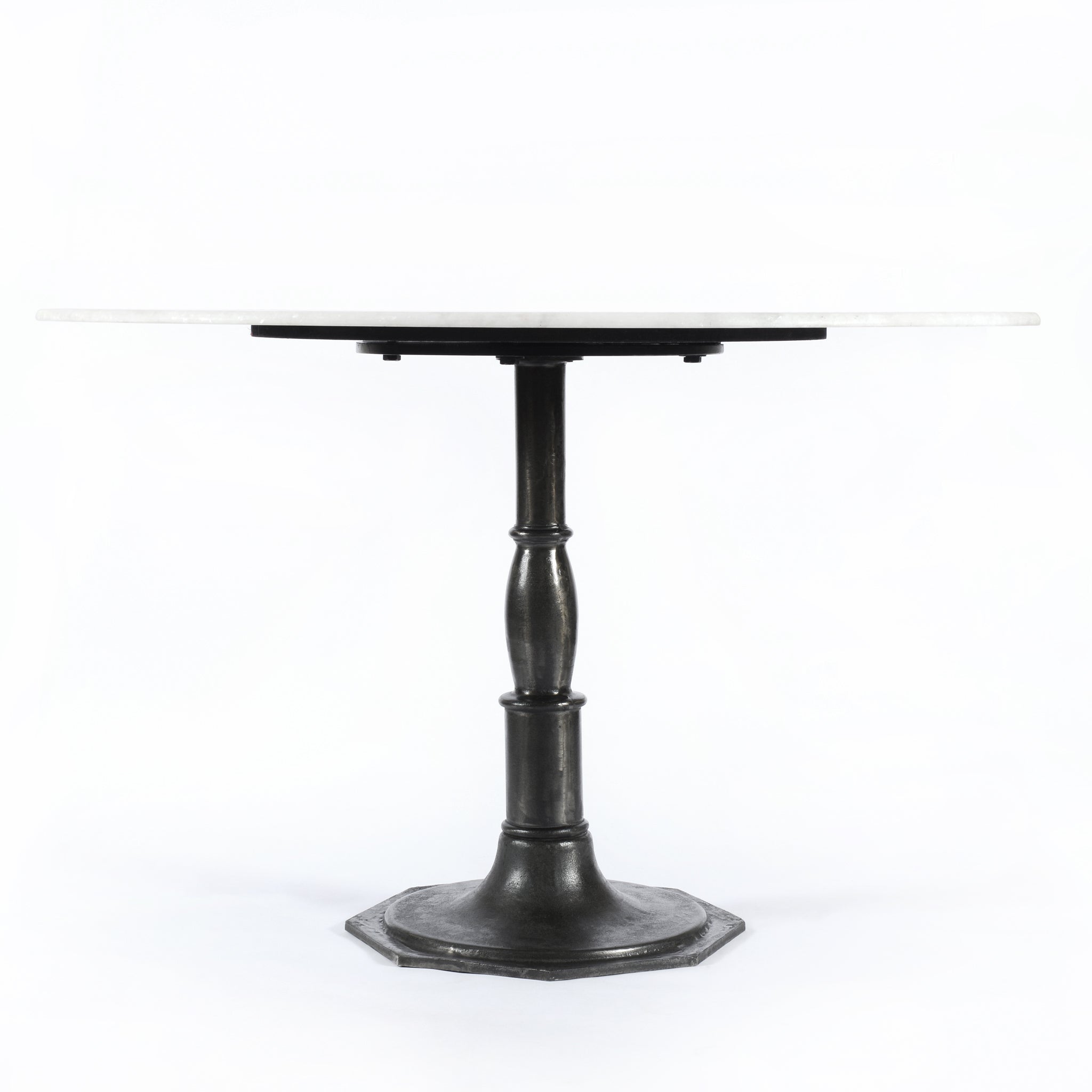 The Lucy Round Marble Dining Table from Four Hands beautifully captures the French industrial meets dining table vibe. Beautifully detailed, 8-sided cast iron pedestal supports a dramatic white marble top with a bull-nosed edge.