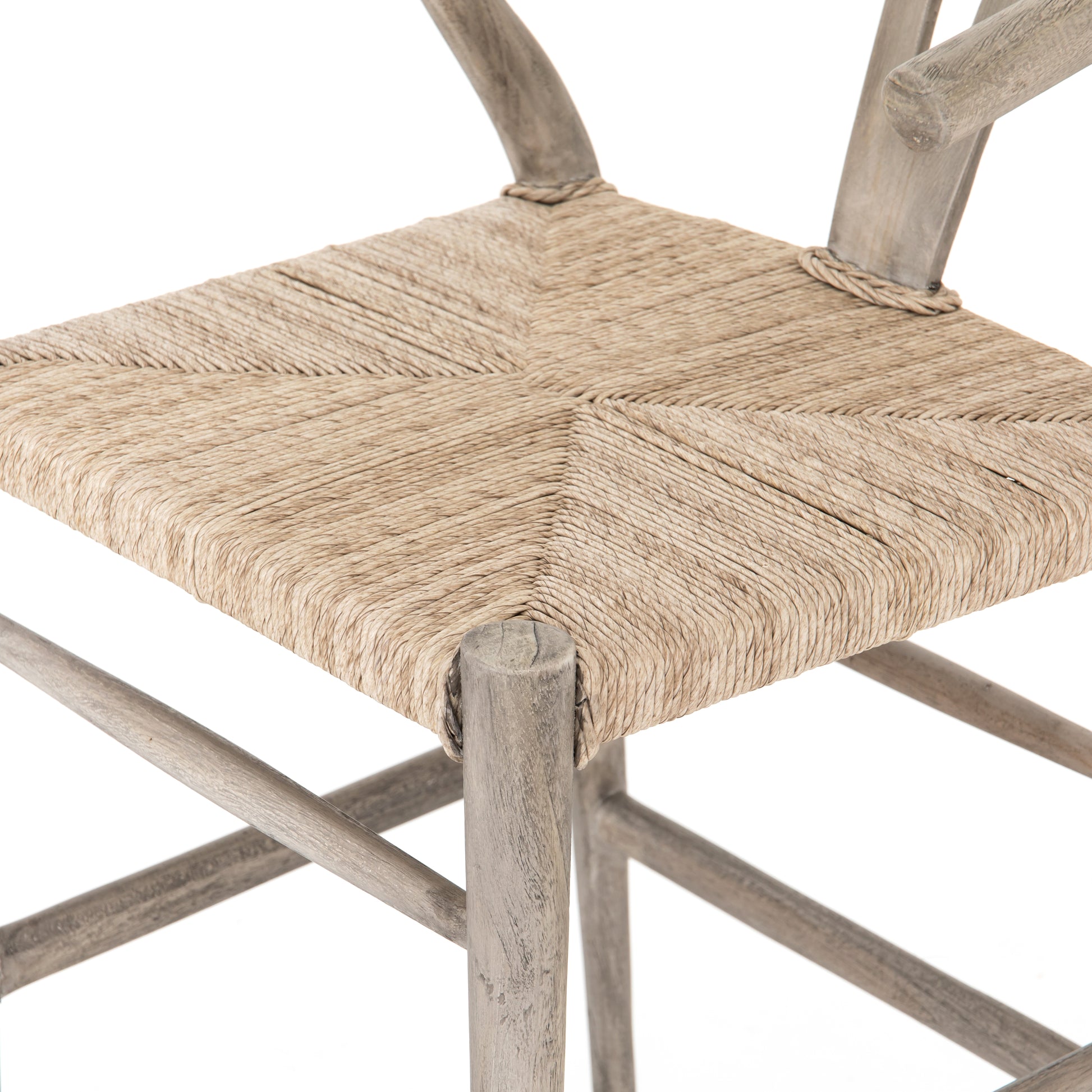 Modern curves redefine the classic wishbone-style counter stool. Vintage white all-weather wicker is woven for a dose of fresh texture within weathered grey teak framing. Cover or store indoors during inclement weather and when not in use.  Pictured in Weathered Grey. Also available in Black Teak and Matte Sealed Teak.  Overall Size: 21.50"w x 22.50"d x 38.50"h Seat Depth: 18.25" Seat Height: 26.50"