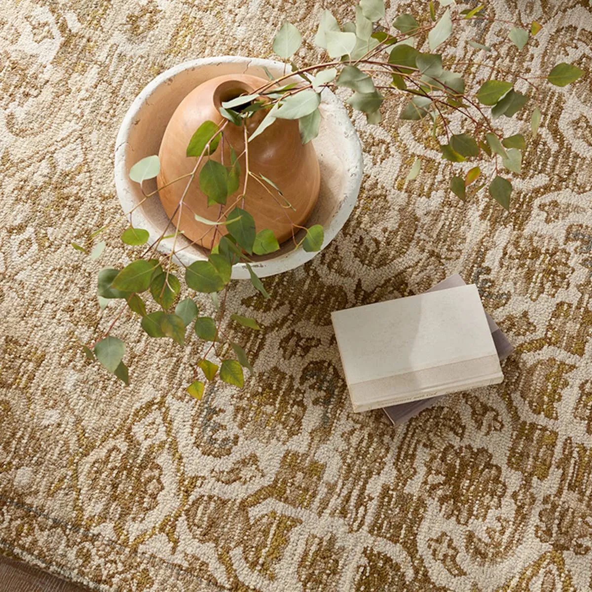 The hand-tufted Cardamom Sarang boasts vivid jewel tones and uniquely distressed Turkish motifs, crafted to emulate traditional sun-faded, vintage designs. The Sarang rug showcases a floral trellis motif in a mix of warm and earthy hues including brown, gold, cream, beige, and hints of blue. Amethyst Home provides interior design, new home construction design consulting, vintage area rugs, and lighting in the Boston metro area.