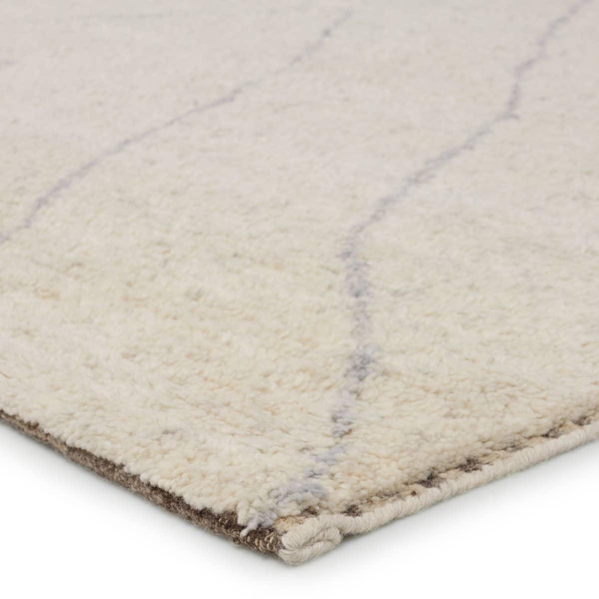 Rich in detail and plush underfoot, the Indira Laverna is made up of neutral-toned modern Moroccan styles. The Laverna area rug features a slight sheen and luxurious hand-knotted construction of natural wool and viscose. A light trellis design provides geometric interest in a silver-blue hue on a soft ivory backdrop. Amethyst Home provides interior design, new home construction design consulting, vintage area rugs, and lighting in the Calabasas metro area.