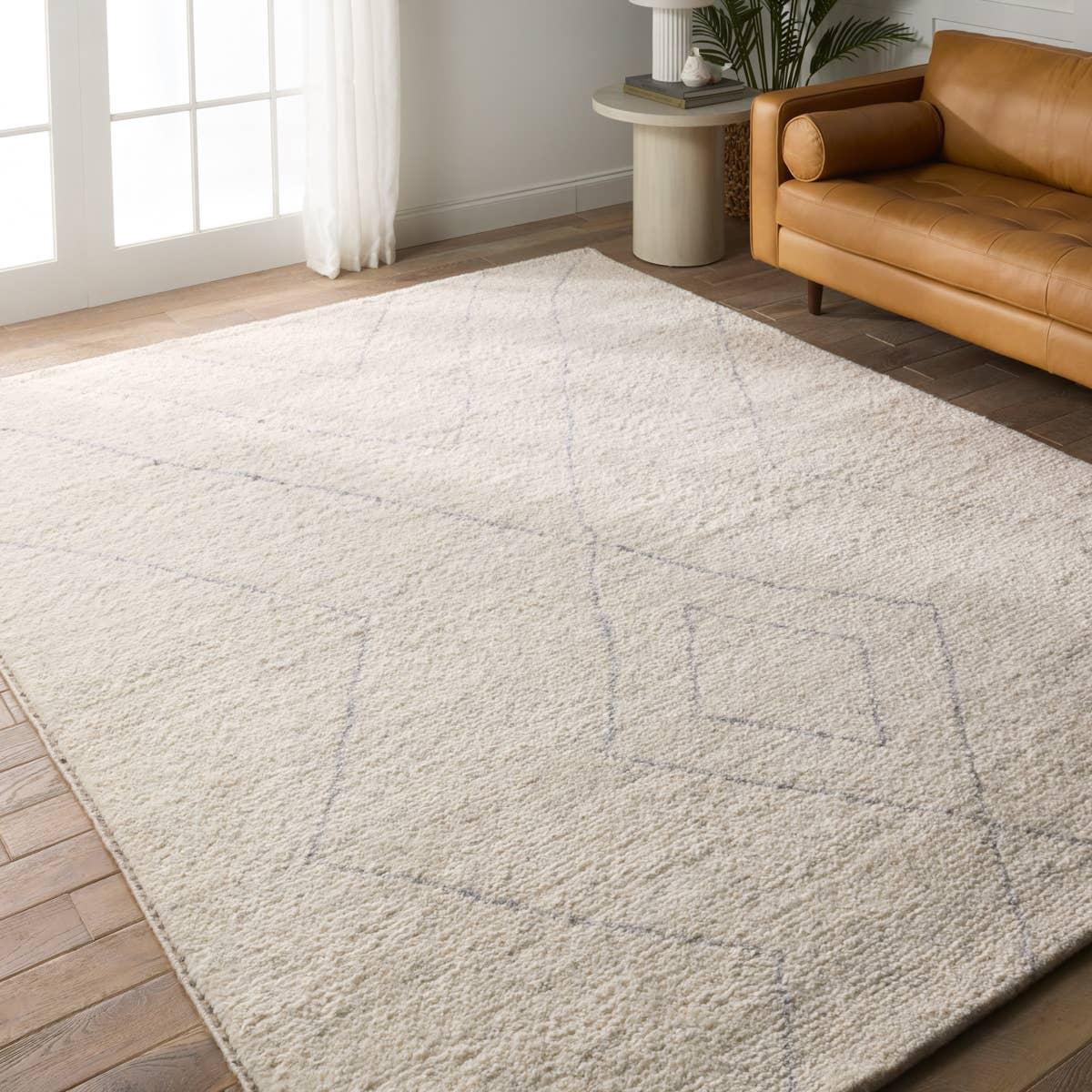 Rich in detail and plush underfoot, the Indira Laverna is made up of neutral-toned modern Moroccan styles. The Laverna area rug features a slight sheen and luxurious hand-knotted construction of natural wool and viscose. A light trellis design provides geometric interest in a silver-blue hue on a soft ivory backdrop. Amethyst Home provides interior design, new home construction design consulting, vintage area rugs, and lighting in the Des Moines metro area.
