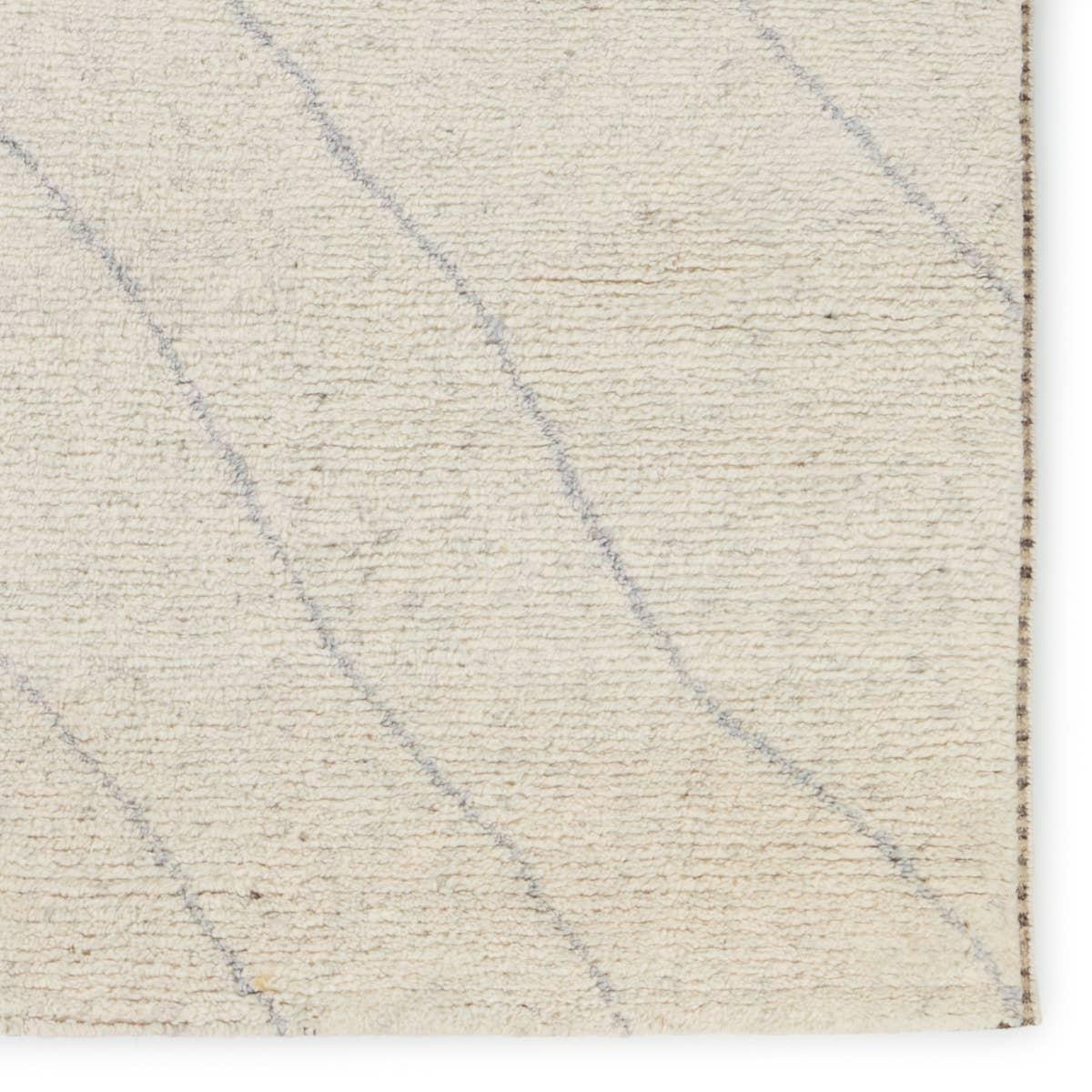 Rich in detail and plush underfoot, the Indira Laverna is made up of neutral-toned modern Moroccan styles. The Laverna area rug features a slight sheen and luxurious hand-knotted construction of natural wool and viscose. A light trellis design provides geometric interest in a silver-blue hue on a soft ivory backdrop. Amethyst Home provides interior design, new home construction design consulting, vintage area rugs, and lighting in the Nashville metro area.