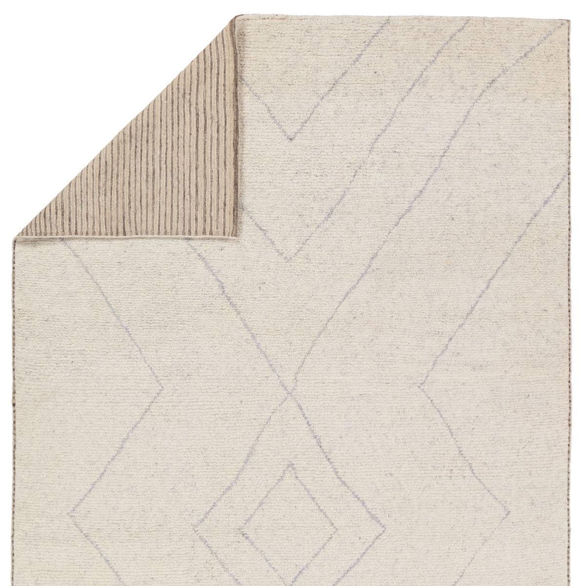 Rich in detail and plush underfoot, the Indira Laverna is made up of neutral-toned modern Moroccan styles. The Laverna area rug features a slight sheen and luxurious hand-knotted construction of natural wool and viscose. A light trellis design provides geometric interest in a silver-blue hue on a soft ivory backdrop. Amethyst Home provides interior design, new home construction design consulting, vintage area rugs, and lighting in the Portland metro area.