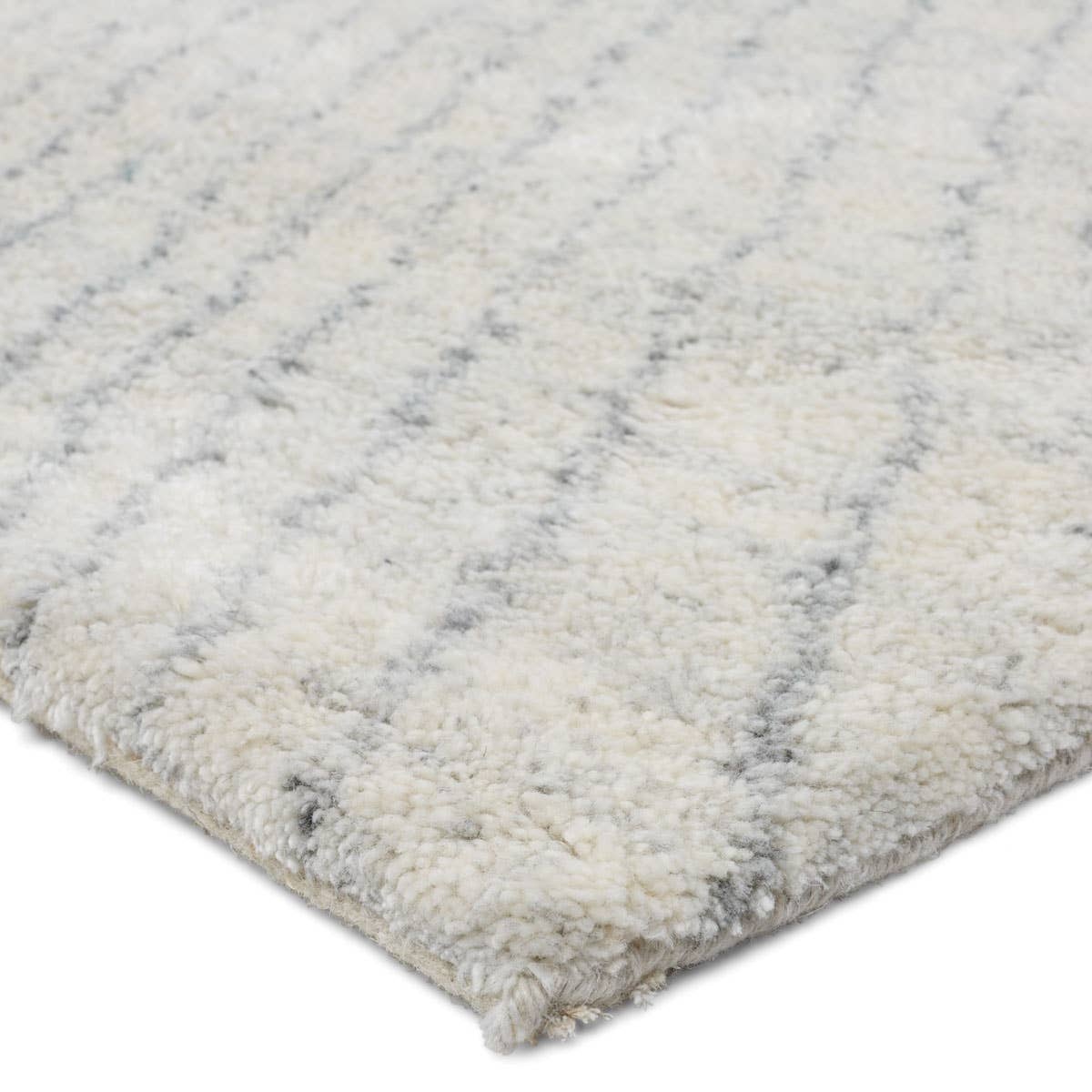 Rich in detail and plush underfoot, the Indira Zivian is made up of neutral-toned modern Moroccan styles. The Zivian area rug features a slight sheen and luxurious hand-knotted construction of natural wool and viscose. A soft linear design provides geometric interest in an light blue hue on an ivory backdrop. Amethyst Home provides interior design, new home construction design consulting, vintage area rugs, and lighting in the Dallas metro area.