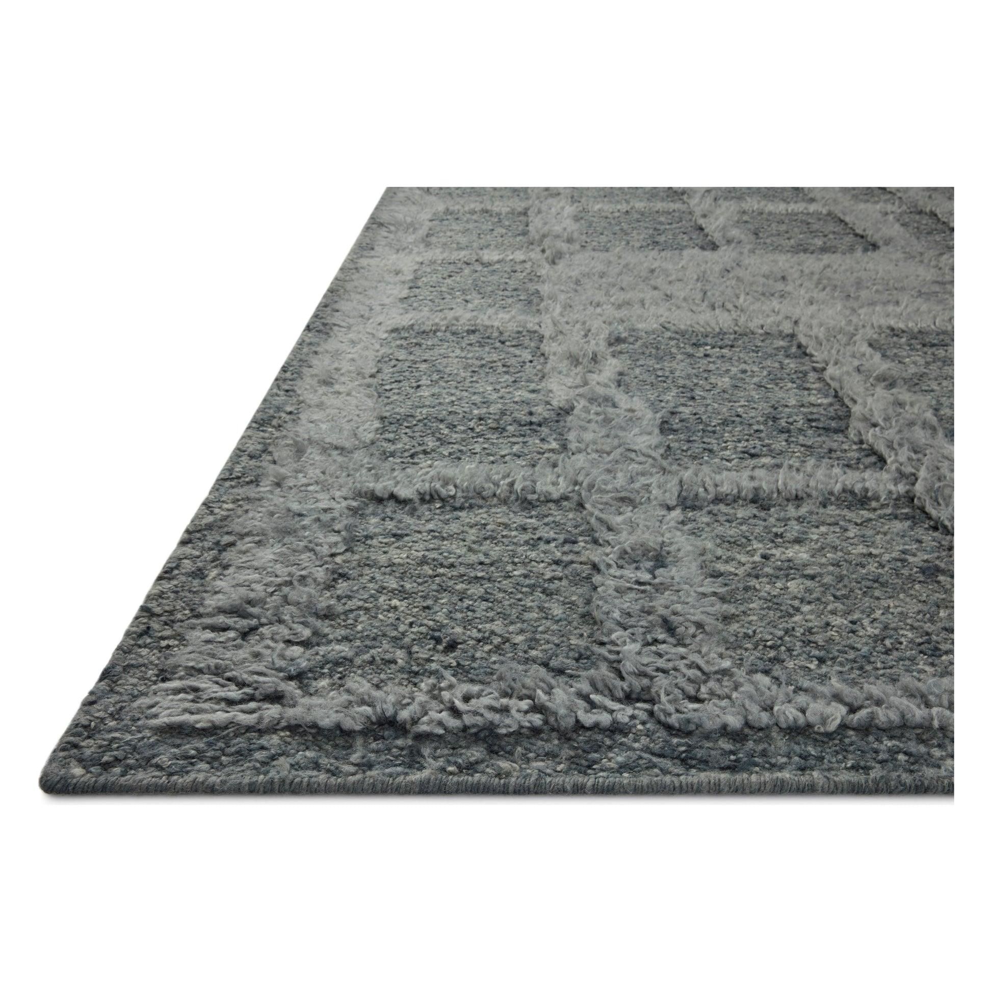 The Cassian Denim rug is a hand-woven wool and cotton area rug with an asymmetrical gridded pattern and high-low texture. The rug’s higher, shaggy pile takes cues from Moroccan designs, while the neutral colors and natural materials make it a cozy addition to any space, especially living rooms and dens. Amethyst Home provides interior design, new home construction design consulting, vintage area rugs, and lighting in the Des Moines metro area.