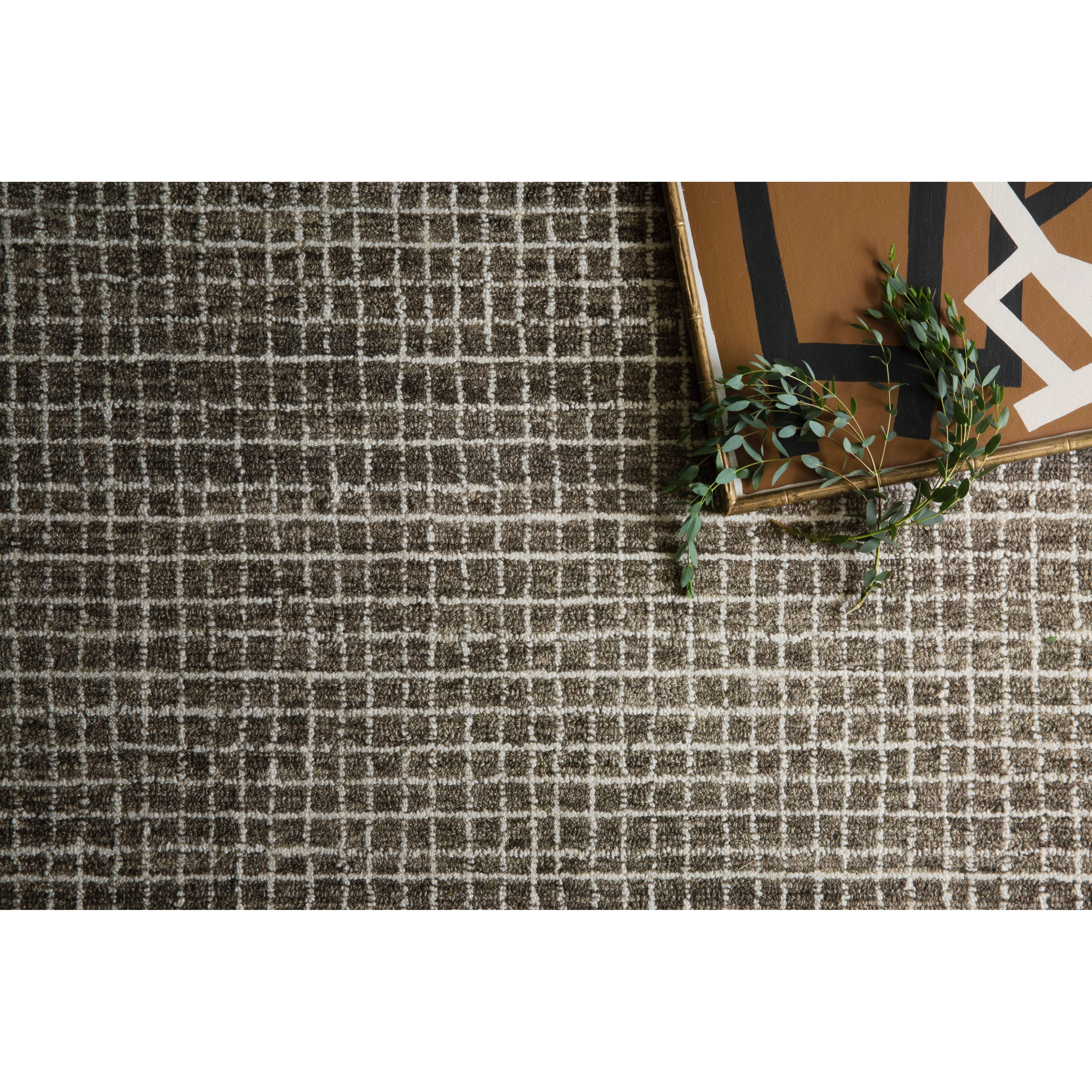 Featuring Giana Charcoal Rug by Loloi at Amethyst Home. Inspired by textural watercolors, the Giana Charcoal Rug from Loloi combines a relaxed grid with soft variations of grey and ivory for an effortless and sophisticated look. Each rug is hooked of 100% wool by artisans for a beautiful textural layer to your home. The soft textures of this rug bring warmth and coz. Amethyst Home provides interior design, new construction, custom furniture, and rugs for the Austin, Dallas, and Houston metro area.