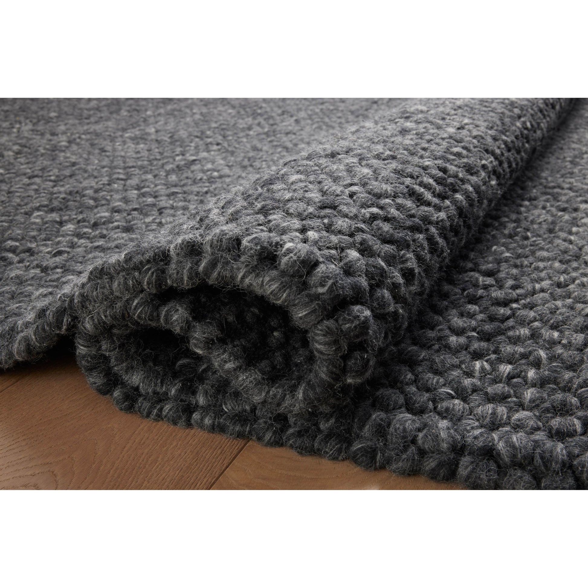 The Hendrick Charcoal Rug is a beautifully textured wool area rug with an elevated ease reminiscent of a cozy handmade sweater. The rug is very plush underfoot, making it equally welcome in bedrooms and living rooms. The hand-woven weave pattern adds dimension while the rug’s color palette is soft, neutral, and serene. Amethyst Home provides interior design, new construction, custom furniture, and area rugs in the Washington metro area.