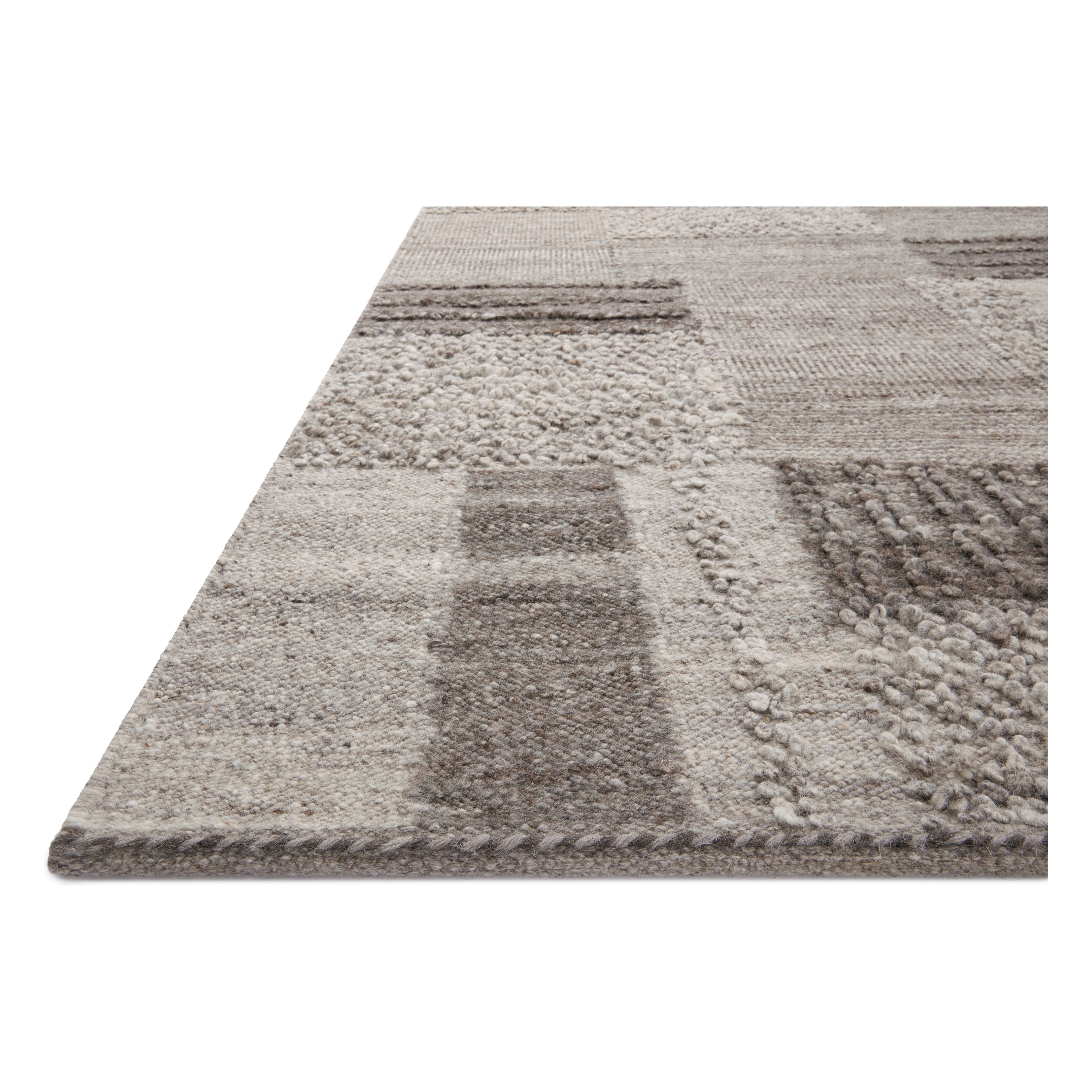 Featuring Manfred Charcoal / Dove Hand-Knotted Rug by Loloi at Amethyst Home. Each area rug in the Manfred Charcoal / Dove Rug collection is meticulously hand-knotted with a technique that creates a high-low texture, adding visual depth and movement. The rug’s patchwork design is casually sophisticated, fitting into living rooms, bedrooms, and dens—anywhere a t. Amethyst Home provides interior design, new home construction design consulting, vintage area rugs, and lighting in the Omaha metro area.
