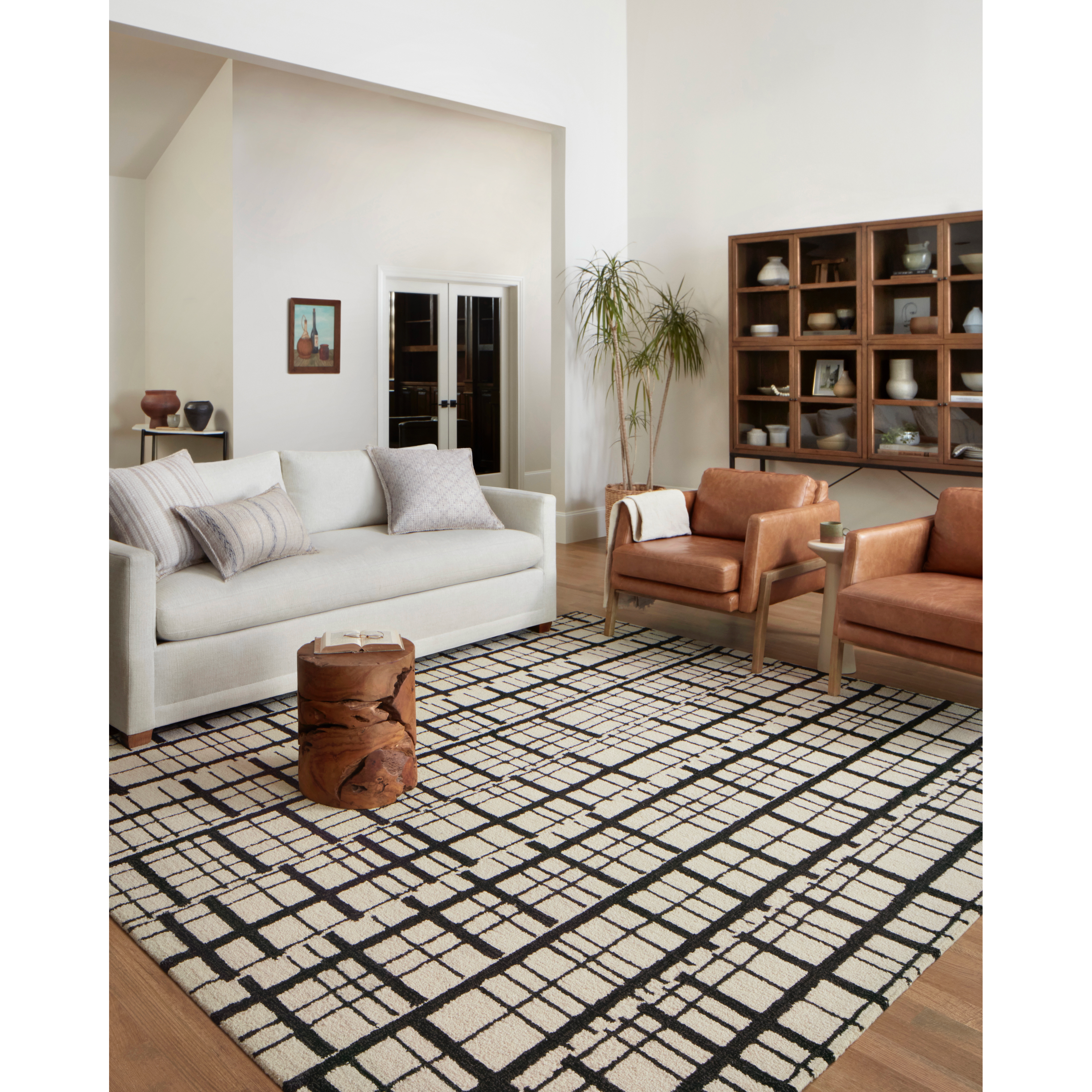 Hand-tufted of wool and jute pile, the Polly POL-02 CJ Black / Ivory rug for Chris Loves Julia x Loloi brings a fresh take on modern yet classic designs. With striking gridded designs toned down by a neutral color palette, Polly is a timeless choice for any room. Amethyst Home provides interior design, new construction, custom furniture, and rugs for the Dallas metro area.