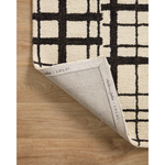 Hand-tufted of wool and jute pile, the Polly POL-02 CJ Black / Ivory rug for Chris Loves Julia x Loloi brings a fresh take on modern yet classic designs. With striking gridded designs toned down by a neutral color palette, Polly is a timeless choice for any room. Amethyst Home provides interior design, new construction, custom furniture, and rugs for the Nashville metro area.