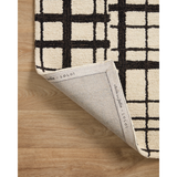 Hand-tufted of wool and jute pile, the Polly POL-02 CJ Black / Ivory rug for Chris Loves Julia x Loloi brings a fresh take on modern yet classic designs. With striking gridded designs toned down by a neutral color palette, Polly is a timeless choice for any room. Amethyst Home provides interior design, new construction, custom furniture, and rugs for the Nashville metro area.