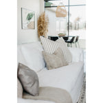 An Amethyst essential: dreamy feather top cushion covers a full upholstered frame.  Slipcovered in an ethereal white linen machine washable slipcover — made just for you in North Carolina. Amethyst Home provides interior design, new home construction design consulting, vintage area rugs, and lighting in the Seattle metro area.