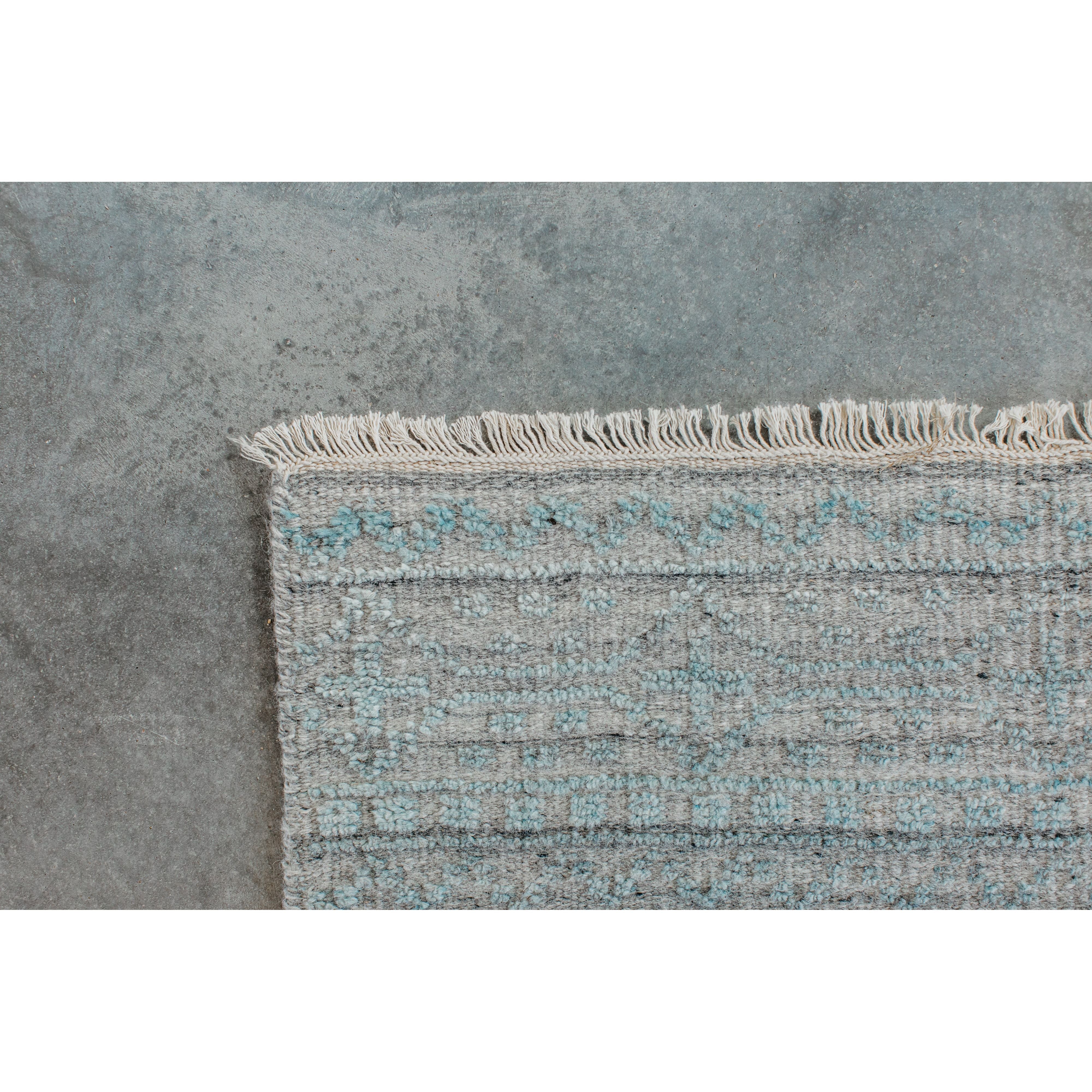 Both timeless and modern, the Idris Spa area rug from Loloi is meticulously hand-knotted in colors of blue, grey, and ivory. The tonal series features an elevated texture, accentuating the detailed pattern. The Idris Spa rug, also known as ID-03 Spa, is hand-knotted of 70% Viscose and 30% Wool.