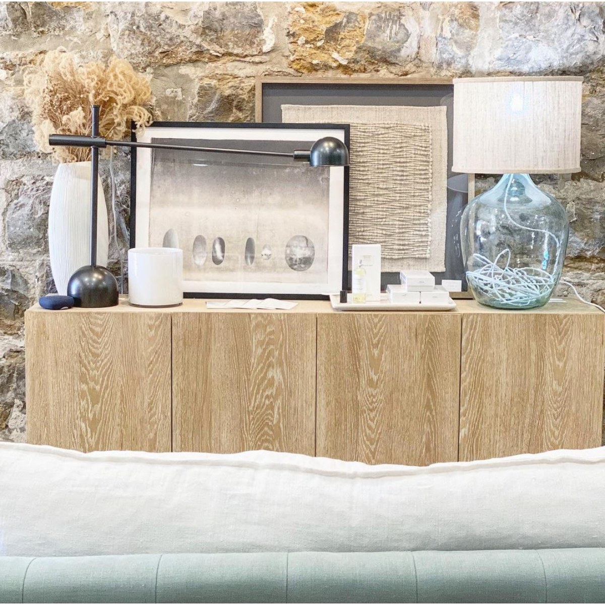 We love the grained matte finish on this Mika Washed Oak Veneer Dining Sideboard. The shelves make this the perfect sideboard for a functional, modernly attractive piece to add to your dining room Amethyst Home provides interior design, new home construction design consulting, vintage area rugs, and lighting in the Newport Beach metro area.