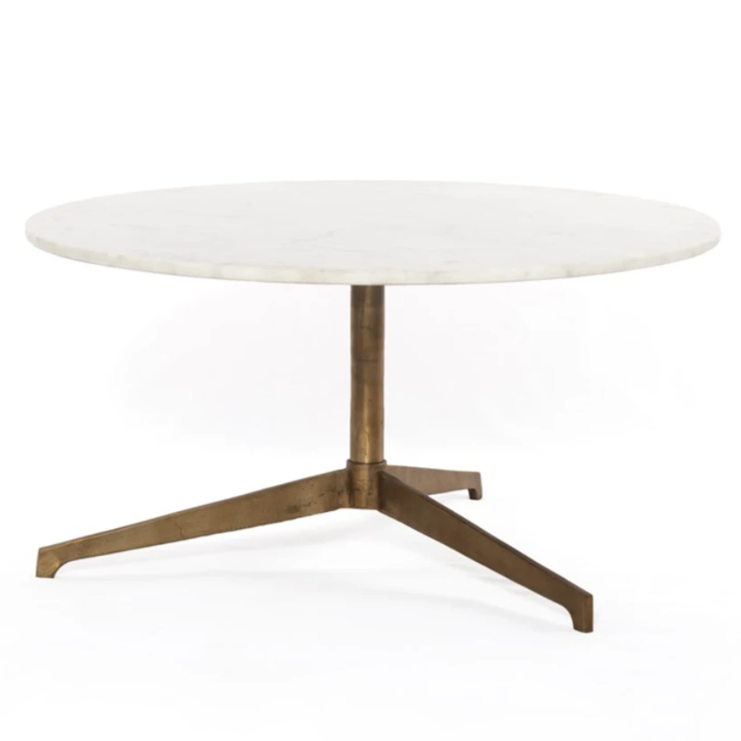 Simple, sophisticated style. The Helen Round Coffee Table has a slim tripod base of raw brass supports a rounded tabletop of polished white marble. Petite scale perfect for smaller spaces or rooms with a sectional.