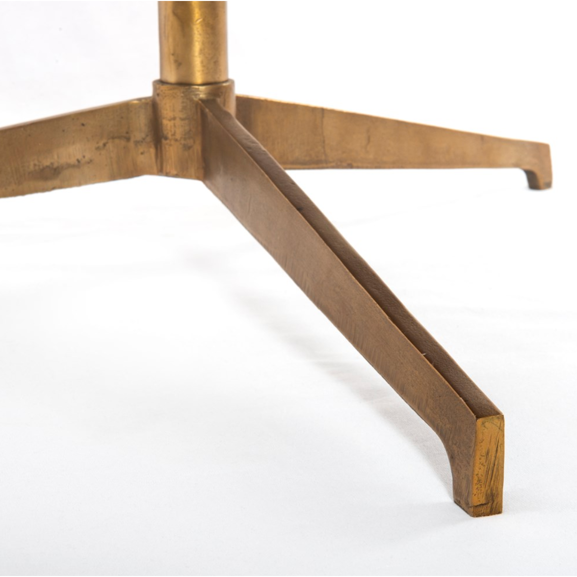 Simple, sophisticated style. The Helen Round Coffee Table has a slim tripod base of raw brass supports a rounded tabletop of polished white marble. Petite scale perfect for smaller spaces or rooms with a sectional.