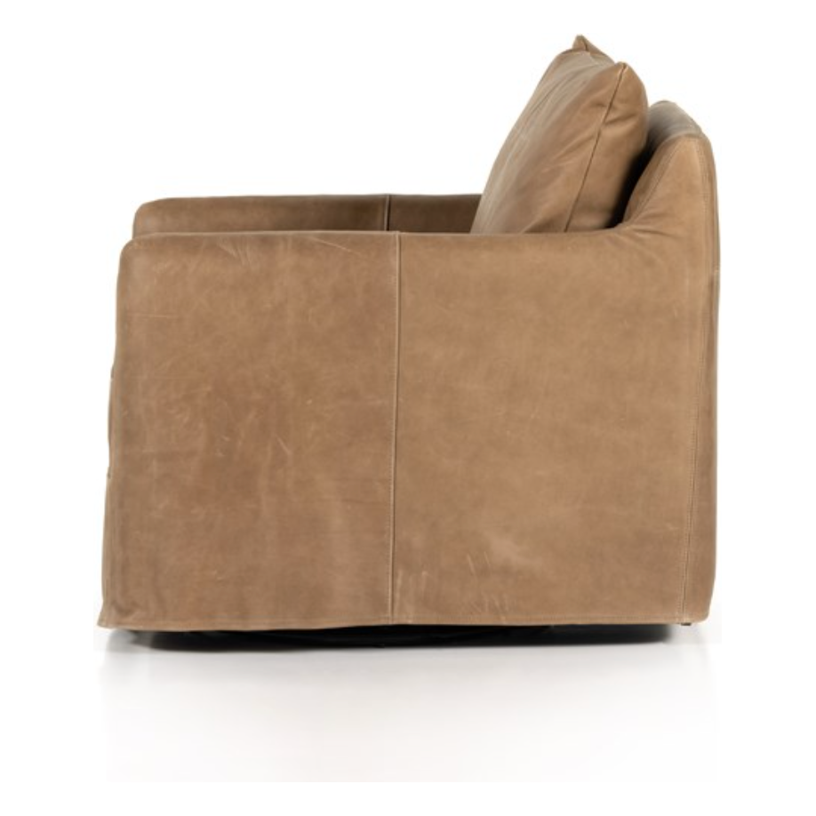 The Freddy Leather Swivel Chair is a slipcovered, leather swivel chair -- perfect for moody rooms. The chair features a comfortable, plush back and supportive seat. Please expect natural distressing. Amethyst Home provides interior design, new home construction design consulting, vintage area rugs, and lighting in the Newport Beach metro area.