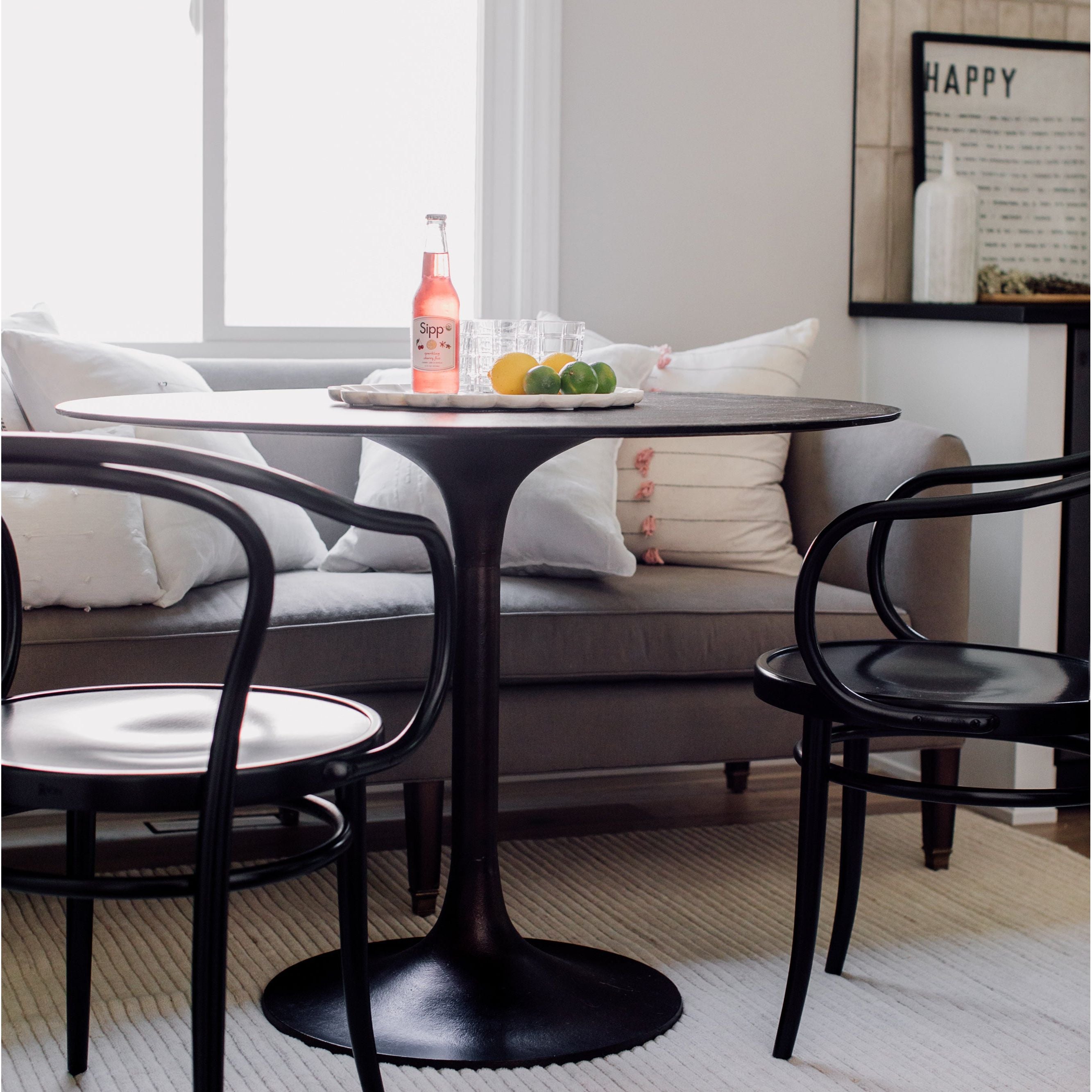 Classic tulip shaping in textural cast-aluminum makes for a modern Simone Antique Rust Bistro Table. Finished in antique rust to bring out alluring highs and lows. Amethyst Home provides interior design, new home construction design consulting, vintage area rugs, and lighting in the Seattle metro area.