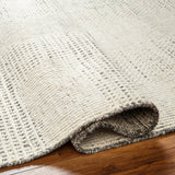 The Tunus Taupe Rug features a globally inspired design made from wool. The hand-knotted rug adds wabi sabi charm to any room. Amethyst Home provides interior design, new home construction design consulting, vintage area rugs, and lighting in the Winter Garden metro area.