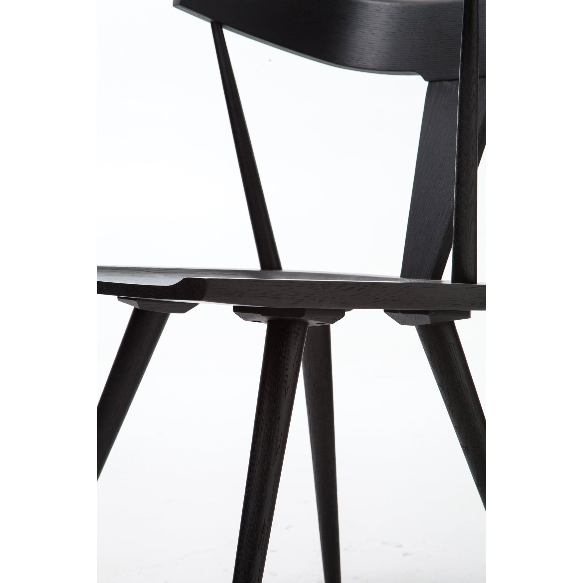 This new take on the mid-century Windsor chair, the Ripley Dining Chair has a bowed, sculptural silhouette. A soft black finish adds movement to the wood by highlighting the natural grain of weathered oak. The chair is perfect for the chic, modern dining room look.
