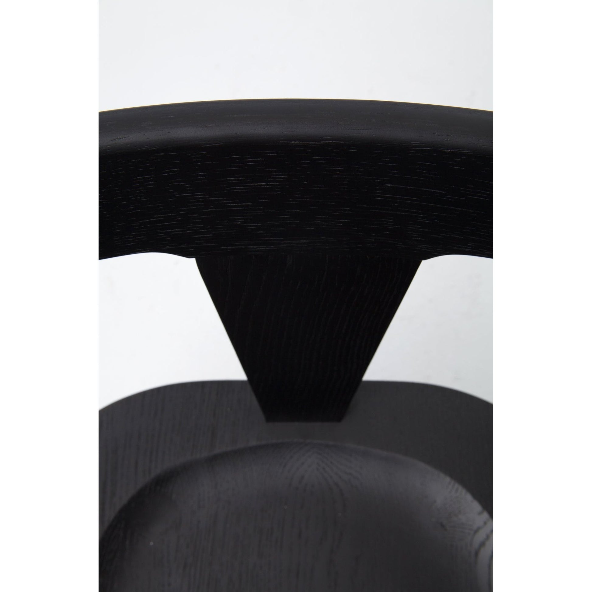 This new take on the mid-century Windsor chair, the Ripley Dining Chair has a bowed, sculptural silhouette. A soft black finish adds movement to the wood by highlighting the natural grain of weathered oak. The chair is perfect for the chic, modern dining room look.