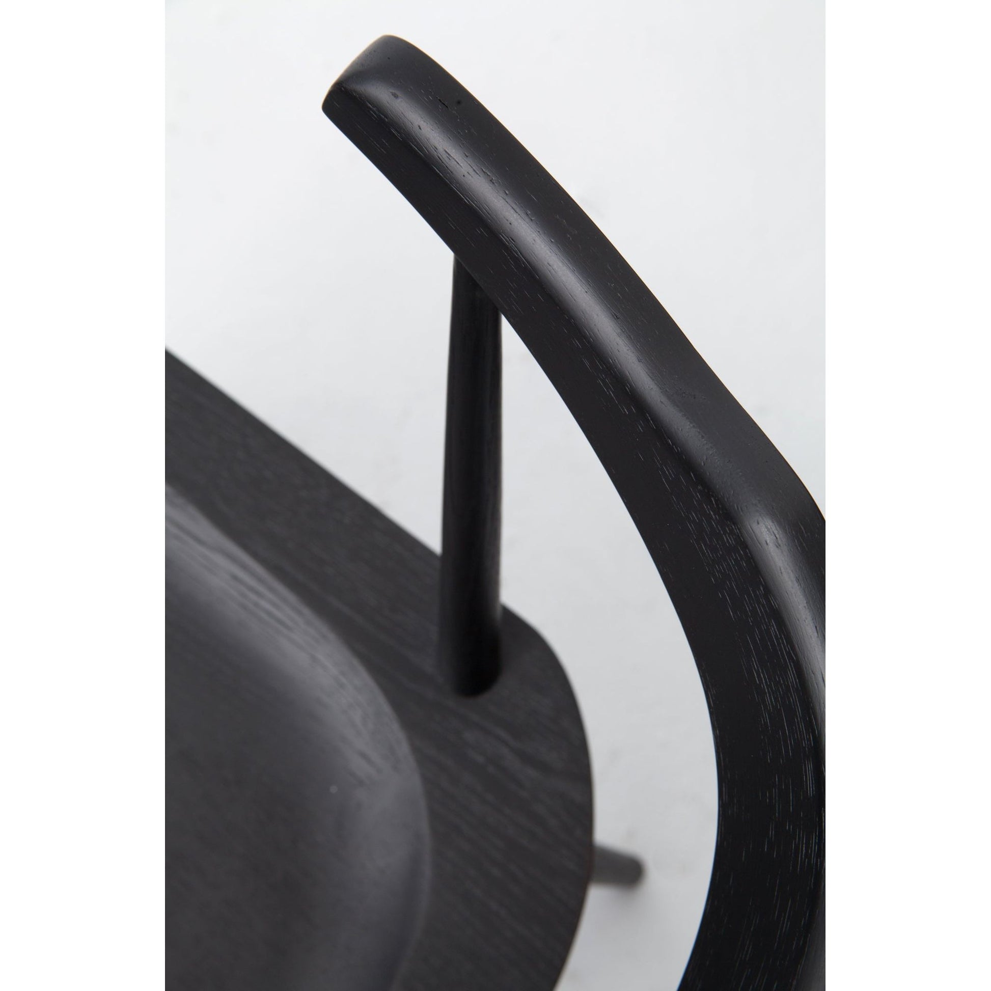 This new take on the mid-century Windsor chair, the Ripley Dining Chair has a bowed, sculptural silhouette. A soft black finish adds movement to the wood by highlighting the natural grain of weathered oak. The chair is perfect for the chic, modern dining room look.