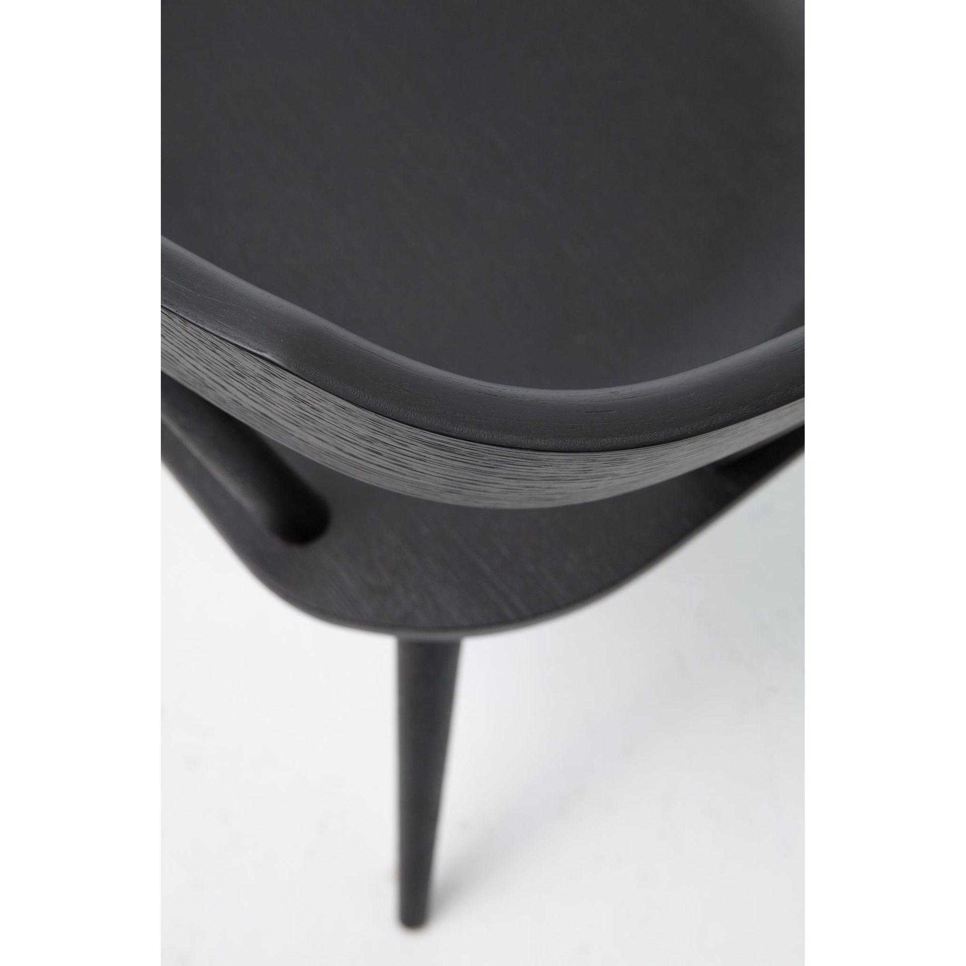 This new take on the mid-century Windsor chair, the Ripley Dining Chair has a bowed, sculptural silhouette. A soft black finish adds movement to the wood by highlighting the natural grain of weathered oak. The chair is perfect for the chic, modern dining room look.