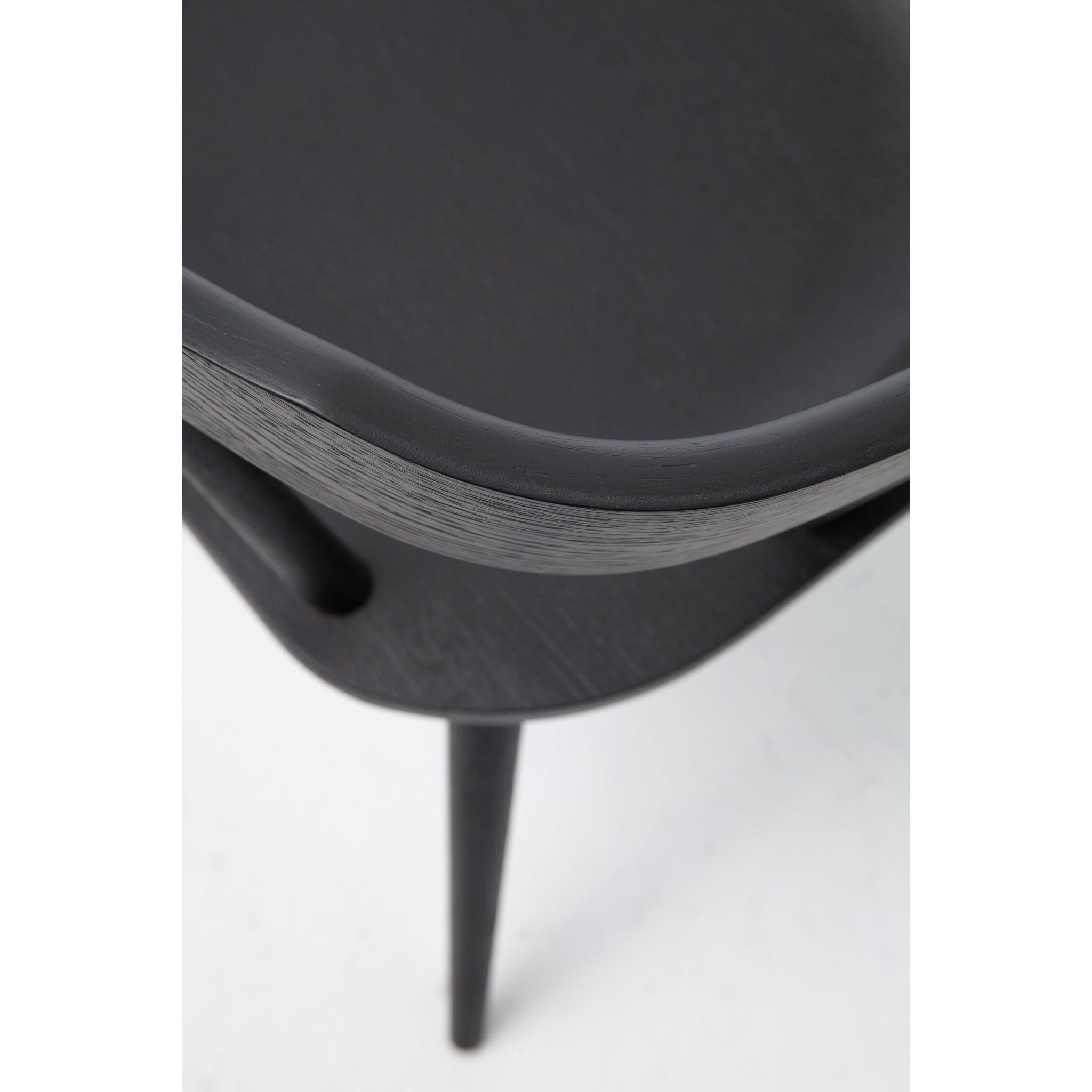 This new take on the mid-century Windsor chair, the Ripley Dining Chair has a bowed, sculptural silhouette. A soft black finish adds movement to the wood by highlighting the natural grain of weathered oak. The chair is perfect for the chic, modern dining room look.