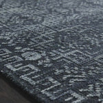 The Idris Ink area rug from Loloi is meticulously hand-knotted of viscose and wool. You will love this rug because the rug is:  Perfect for entryways, living rooms, and bedrooms Easy to clean and maintain Gorgeous with the intricate pattern and patina Warms up any room with the high / low pile Hand-Knotted 70% Viscose | 30% Wool ID-03 Ink