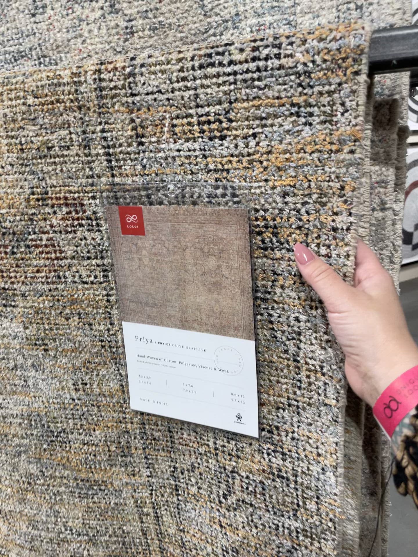 Load video: Hand-woven by skilled artisans, the Priya Olive / Graphite Area Rug from Loloi offers beautiful tonal designs accentuated by a carefully curated color palette. Delicate yet strong, Priya is an instant classic made for today&#39;s home.  Hand Woven 51% Cotton | 29% Polyester | 12% Viscose | 8% Wool PRY-03 Olive/Graphite Colors: Brown, Gold, Ivory, Blue