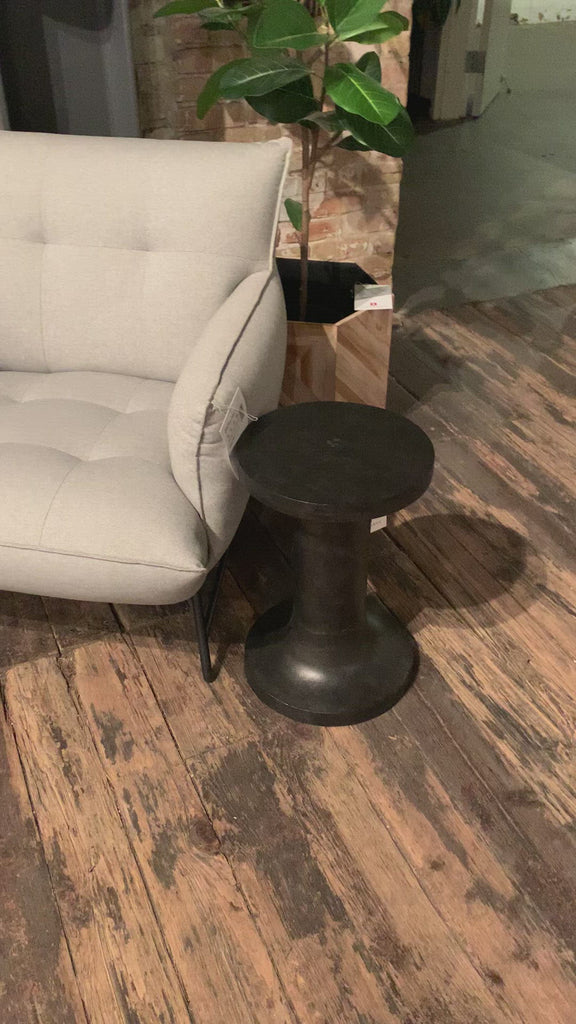 Made from raw black cast aluminum, a dramatically tapered Gino End Table - Raw Black flaunts beautiful high/ low hues and subtle Brutalist vibes. Perfect for setting your book or favorite drink next to.   Overall Dimensions: 13.00"w x 13.00"d x 20.00"h
