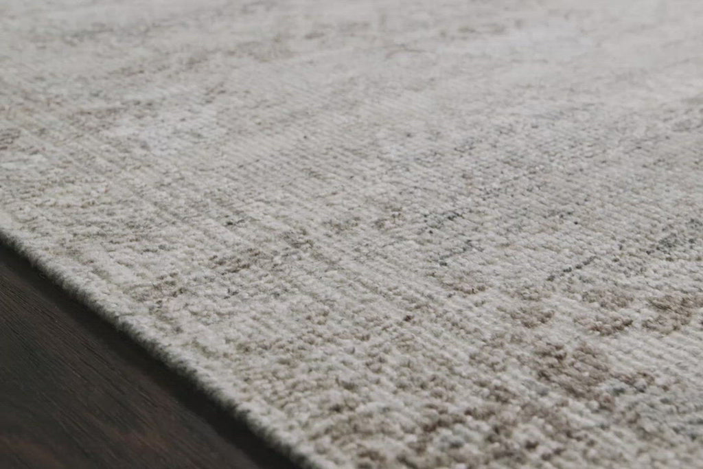 The Idris Stone area rug from Loloi is meticulously hand-knotted of viscose and wool. You will love this rug because the rug is:  Perfect for entryways, living rooms, and bedrooms Easy to clean and maintain Gorgeous with the intricate pattern and patina Warms up any room with the high / low pile Hand-Knotted 70% Viscose | 30% Wool ID-01 Stone