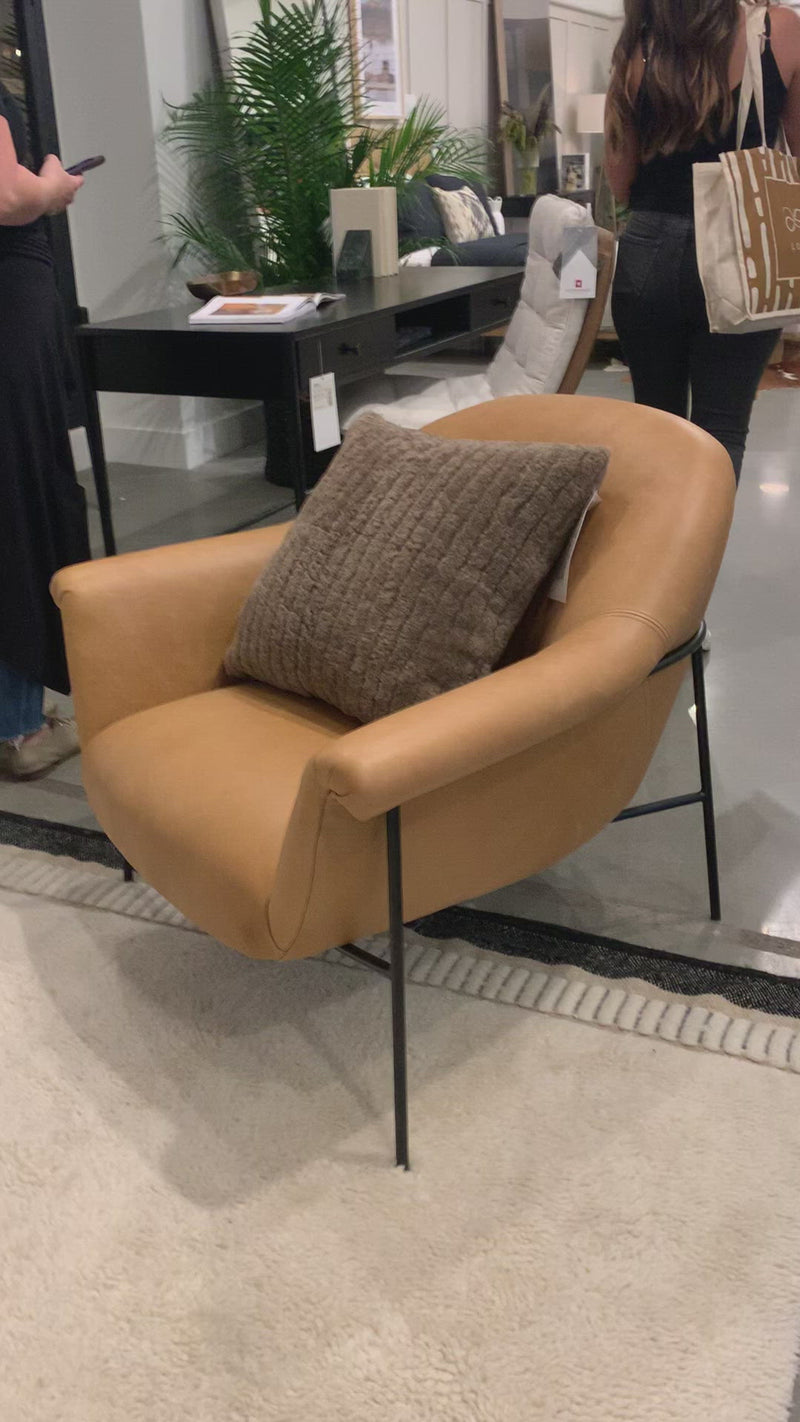 With a curvy silhouette and classic rolled arms, this Suerte Chair - Palermo Butterscotch has butterscotch leather that lends a fresh feel to vintage-inspired accent seating. The airy iron cradle base brings a beautiful balance of scale to any living room or office! Amethyst Home provides interior design, new home construction design consulting, vintage area rugs, and lighting in the Tampa metro area.
