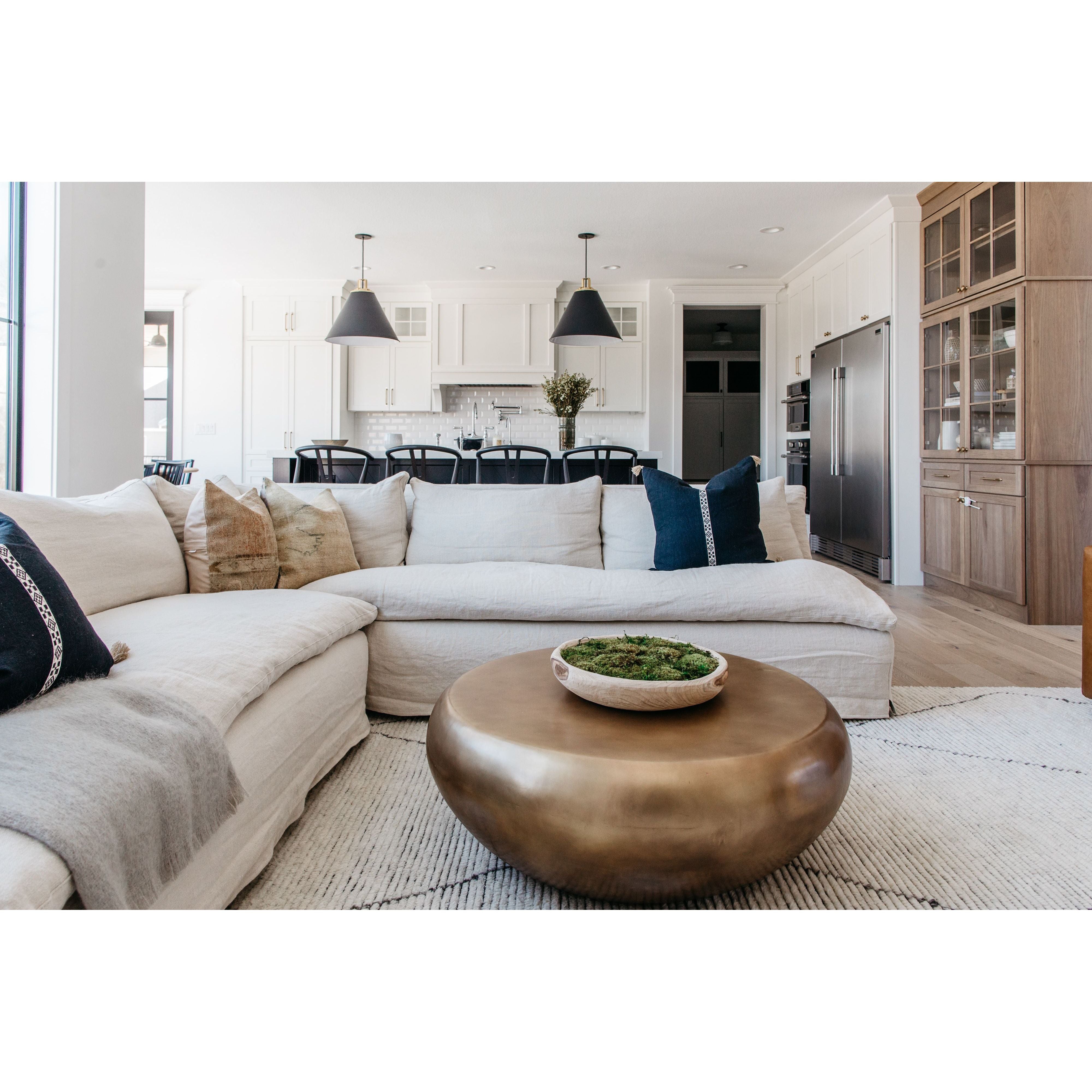 A casual, slipcovered chunky linen sectional by Cisco Brothers, the Laguna 2pc Sectional is the ultimate in casual luxury.  A down-filled seat cushion is supported by springs in a gentle, resting position.  Pair with a one-of-a-kind statement rug for a signature look. Shown in Otis White 100% linen.  Overall dimensions: 113"w x 31"h x 113"d Seat Space: 96"w x 96"d x 16"h