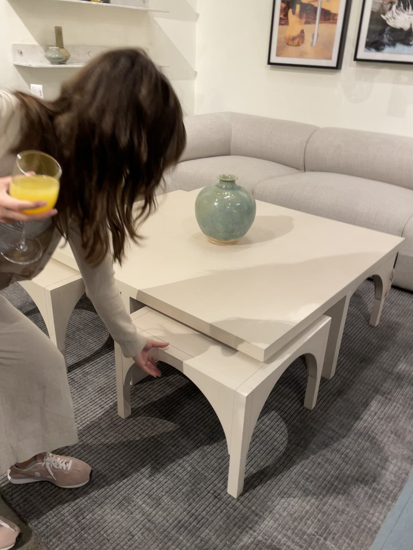 Load video: Meet a forward-thinking oak coffee table as stylish as it is functional with this Amara Coffee Table. We love the beautifully arched sides with four separate nesting tables that slide out to create ample extra surfaces as needed, tucking back under with ease.  Overall Dimensions: 47.25&quot;w x 47.25&quot;d x 18.00&quot;h