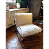 Similar to an Amethyst Favorite Alvar Chair, this Allison Occasional Chair - Faux Skin is textured and beautiful. The thin, matte black metal frame elevates the space for any bedroom, living room, or other space.  Faux Sheepskin Fabric with Black Metal Natural Faux Sheepskin Upholstery with Matte Black Metal 