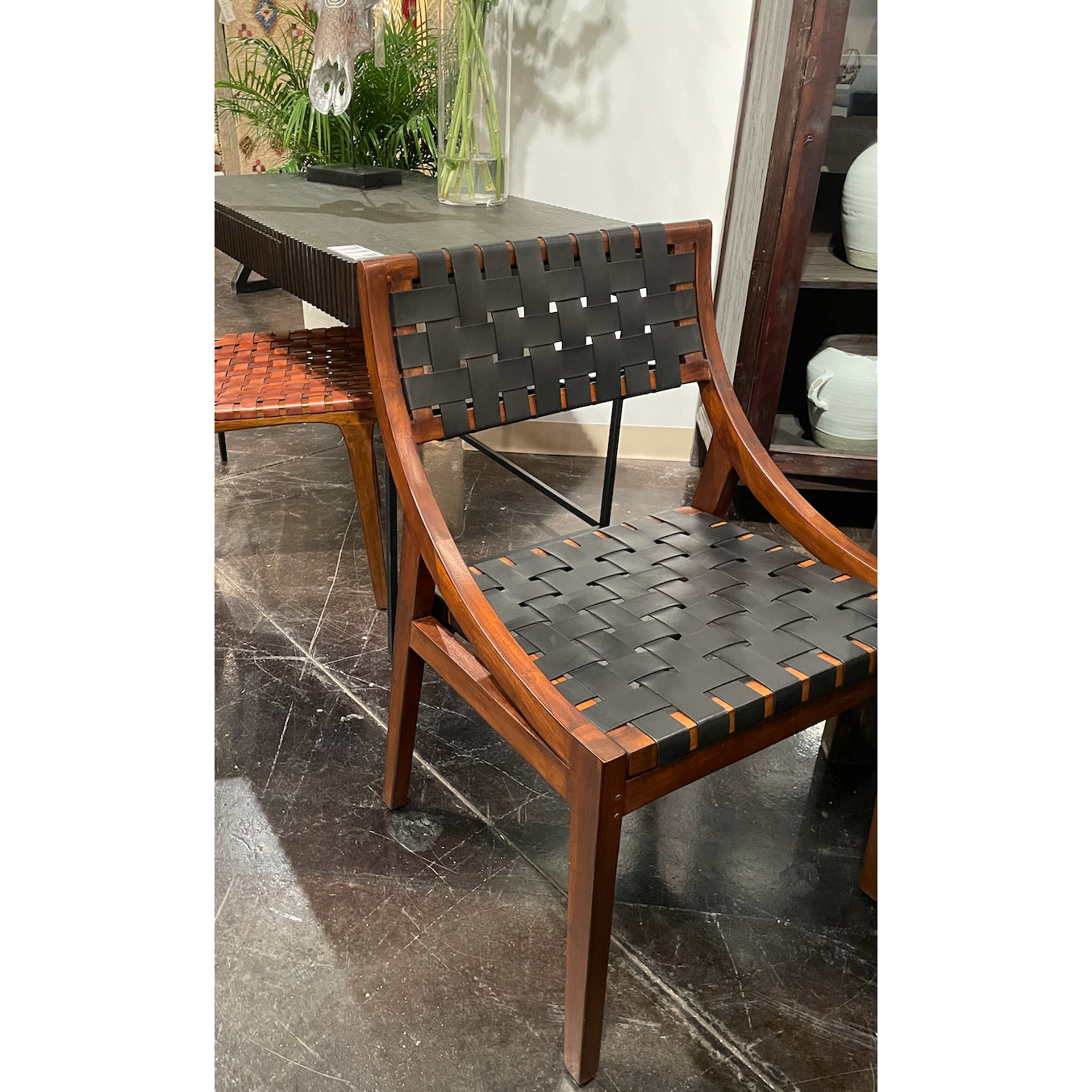 The details are simply amazing on this Camila Dining Chair. Add extra seating with a side chair that's as much a masterpiece of design as it is comfortable.   Teak Frame with Full Grain Leather Weaving Frame in Medium Brown and Black Leather Size: 21"l x 17"d x 33"h