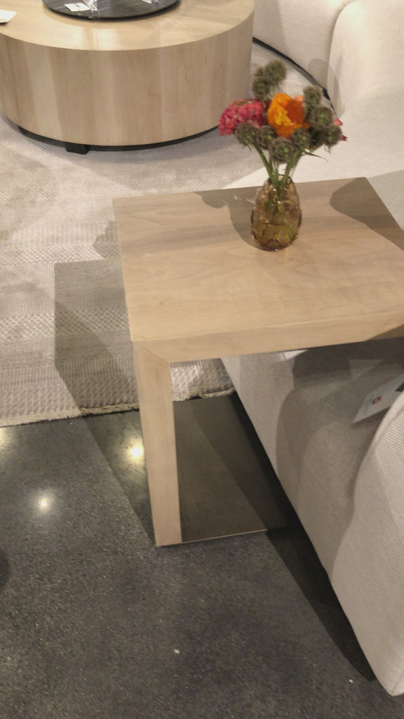 This Hudson C Table - Ashen Walnut has a smooth surface of ashen walnut that appears to float over a gunmetal-finished iron base for slim, angular appeal. Place next to a favorite easy chair for stylish convenience.  Overall Dimensions: 17.50"w x 14.00"d x 22.00"h